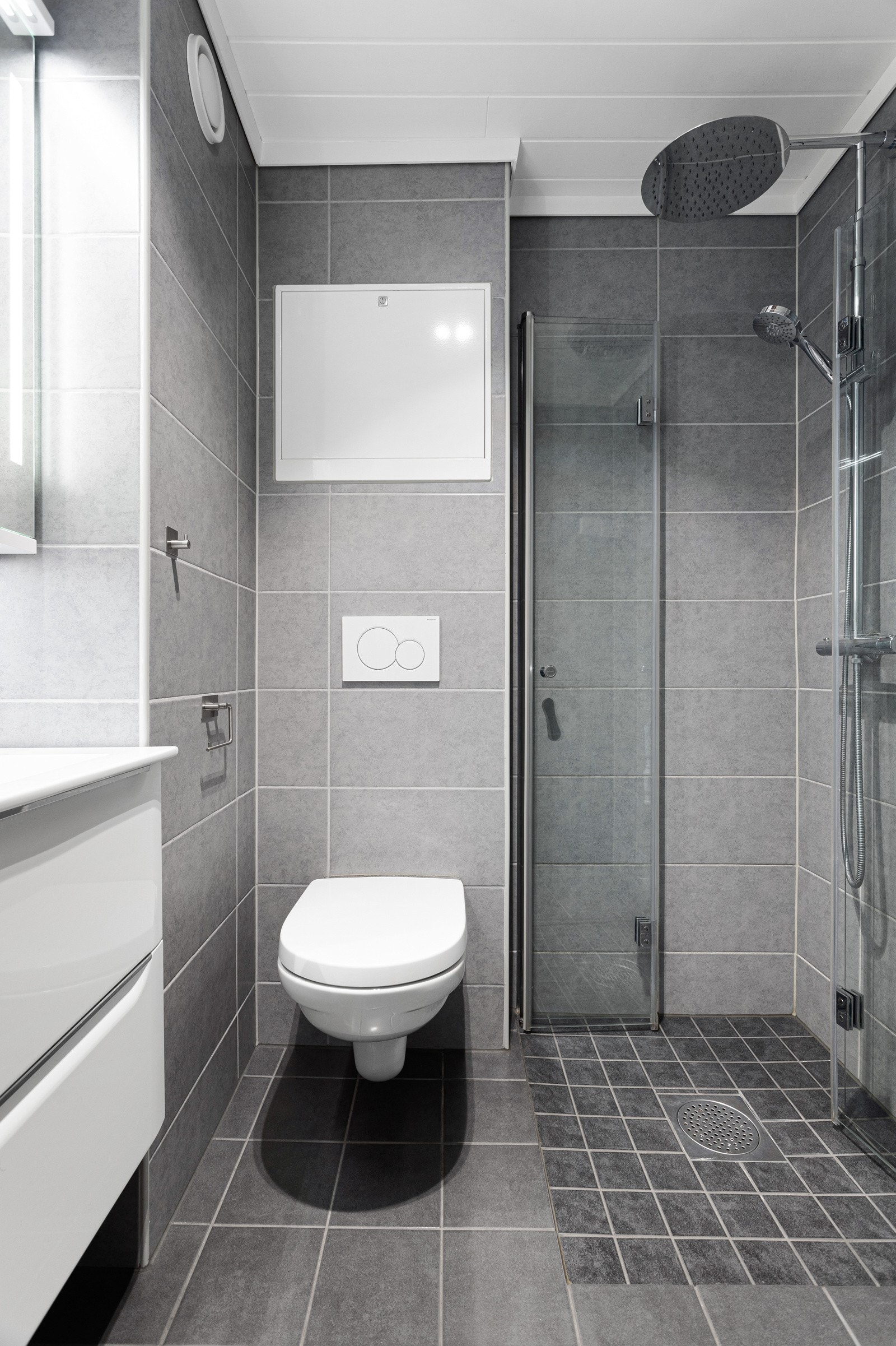 Innredet med dusjnisje, wc, baderomsinnredning med servant og opplegg for vaskemaskin. Galleribilde