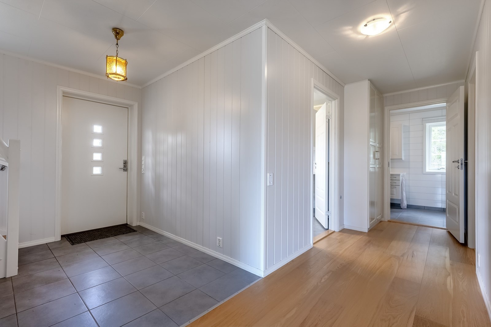 Den romslige entréen har flislagt gulv med undervarme Galleribilde