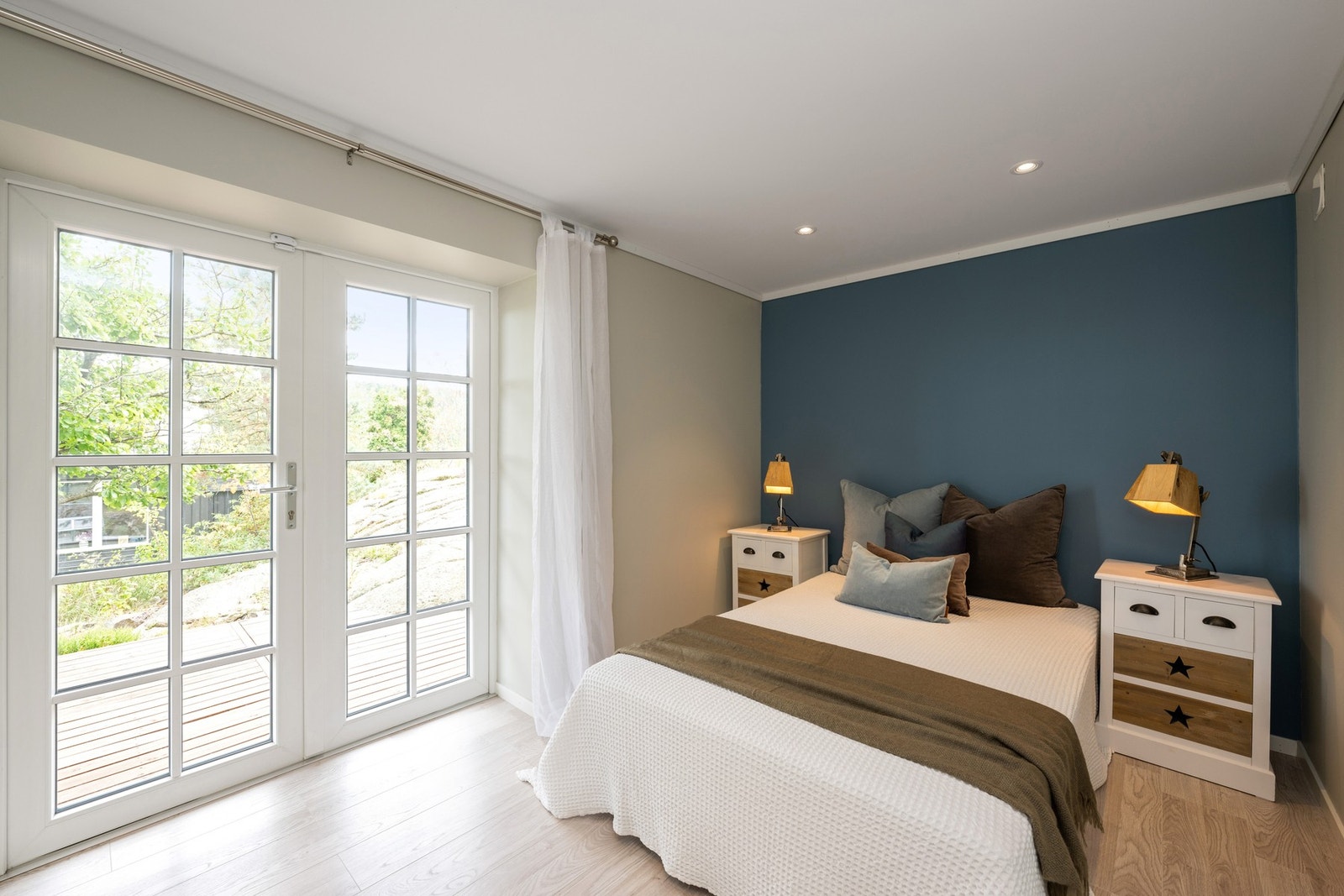 Et av soverommene nede har downlights, duse farger og dør ut til en herlig terrasse. Galleribilde