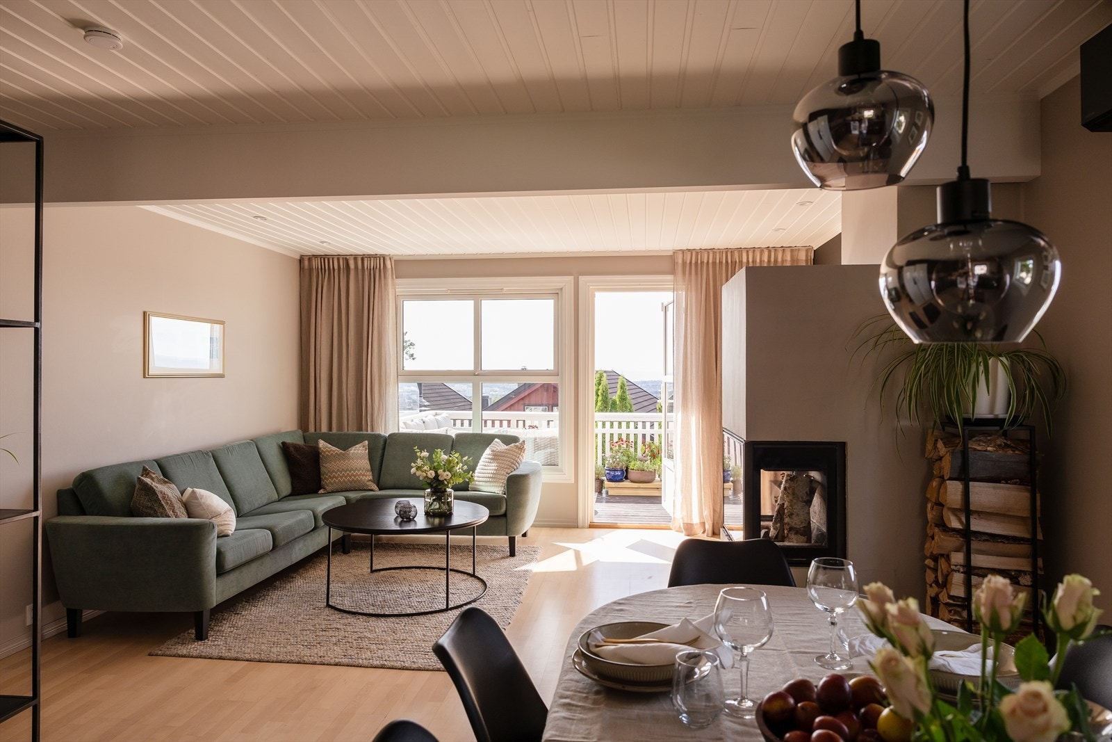 Lys og innbydende stue med store vinduer og utgang til solrik terrasse. Galleribilde