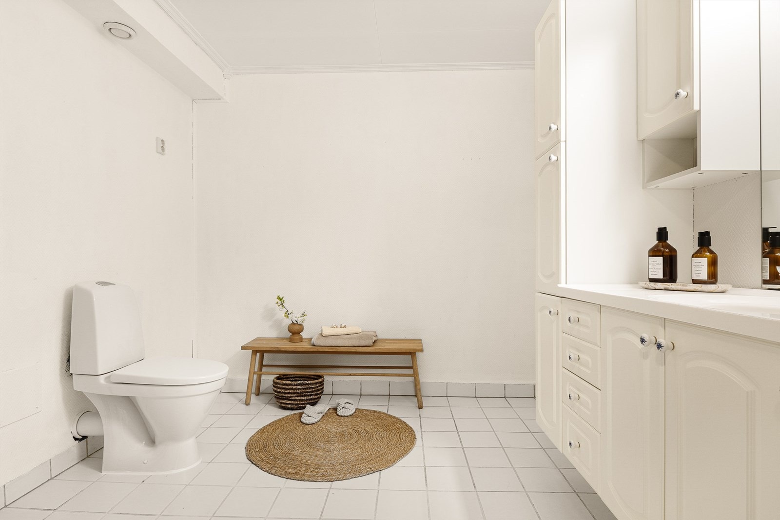 Badet er innredet med toalett, vaske med under- og overskap, høyskap, speil og dusj. Galleribilde