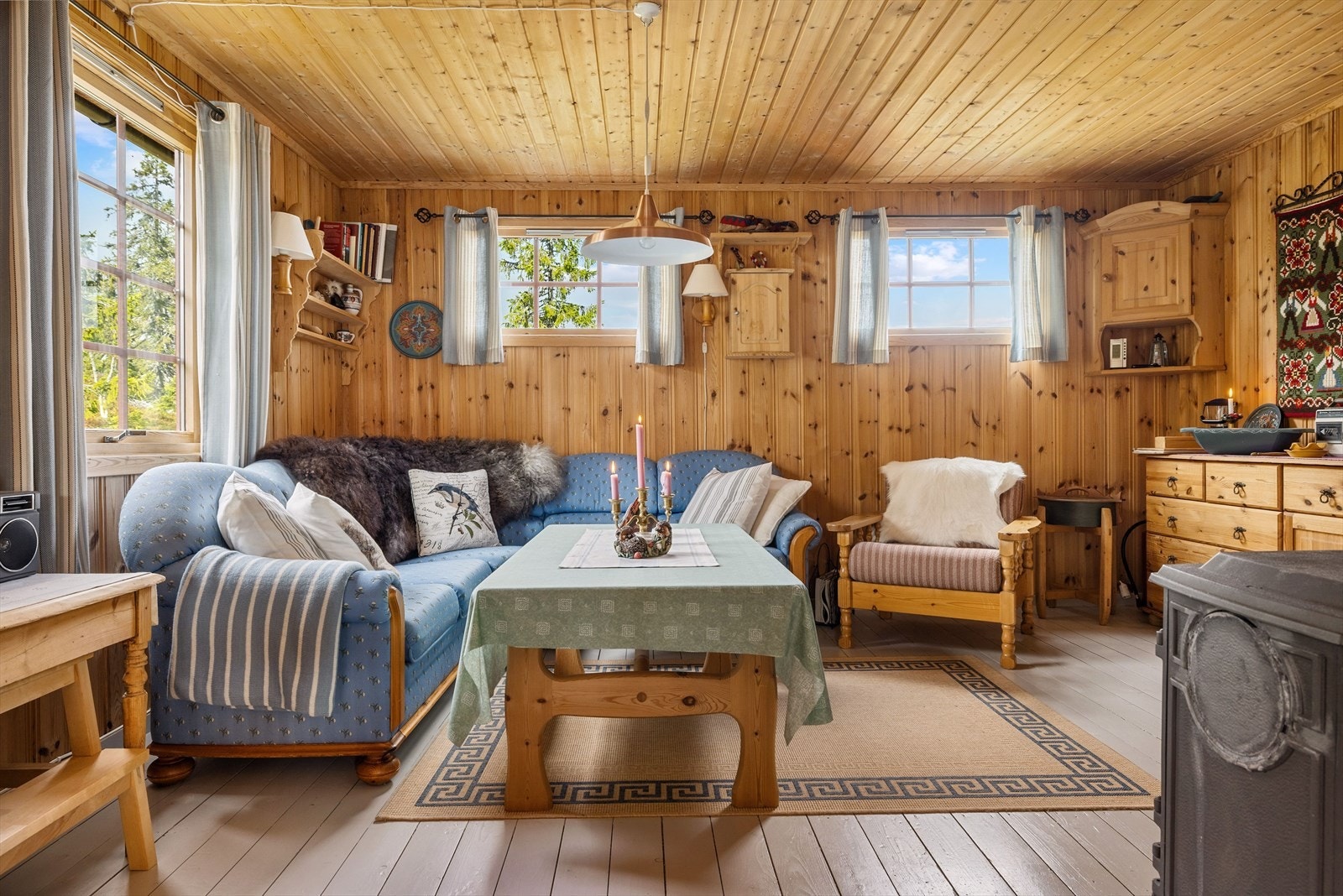 Velholdt normal hyttestandard med malte heltre gulv og stående trepanel på veggene. Galleribilde