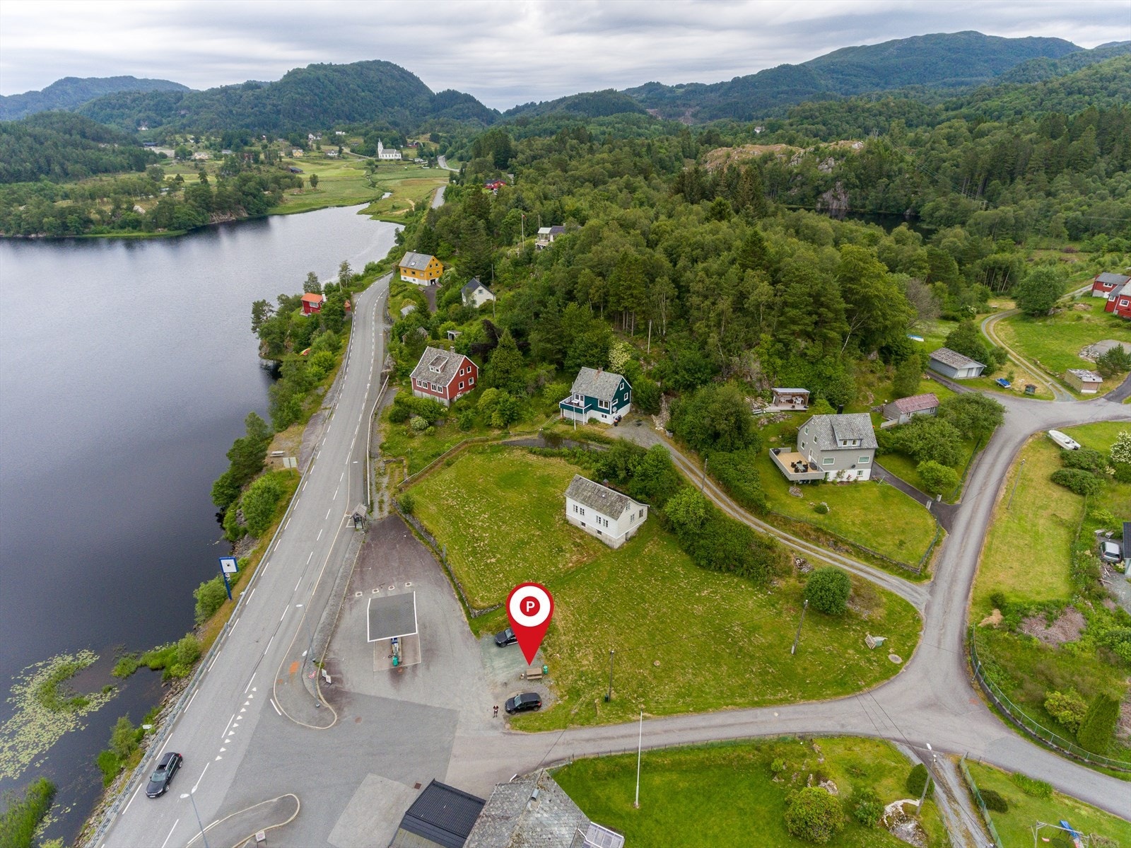Det er opparbeidet stor parkeringsplass på nedsiden av eiendommen med plass til flere biler. Galleribilde