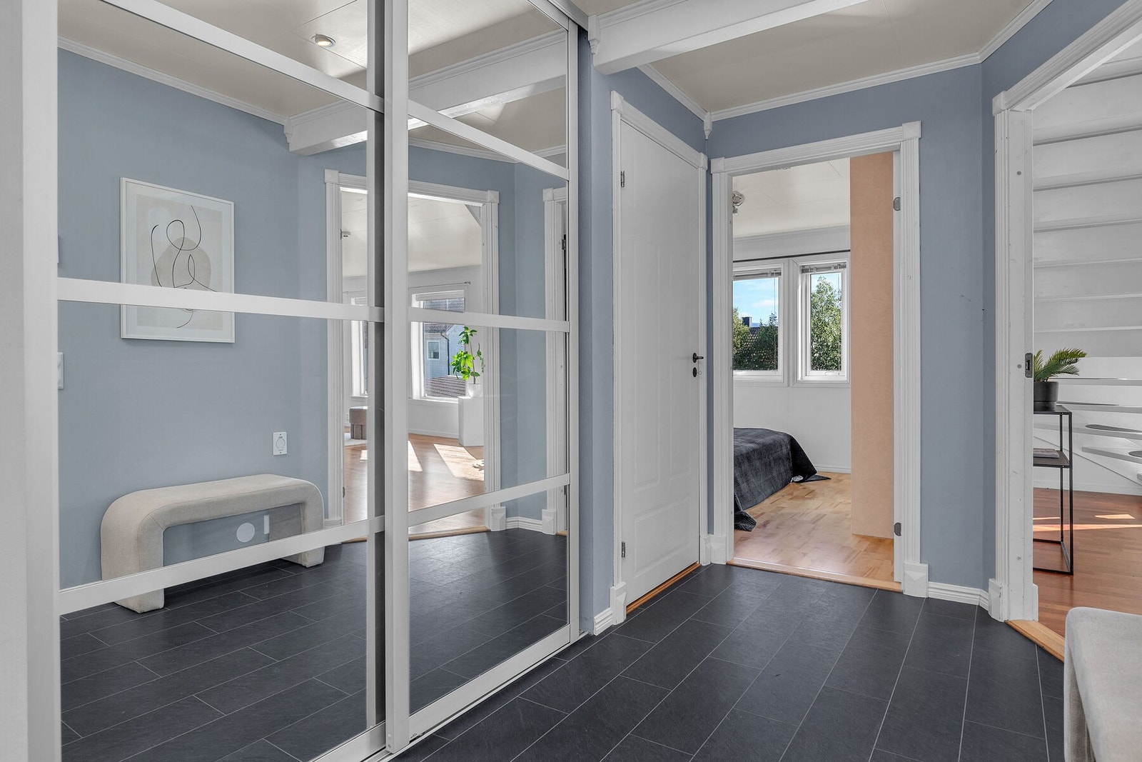 Gangen er praktisk innredet med skyvedørsgarderobe med speildører. Galleribilde