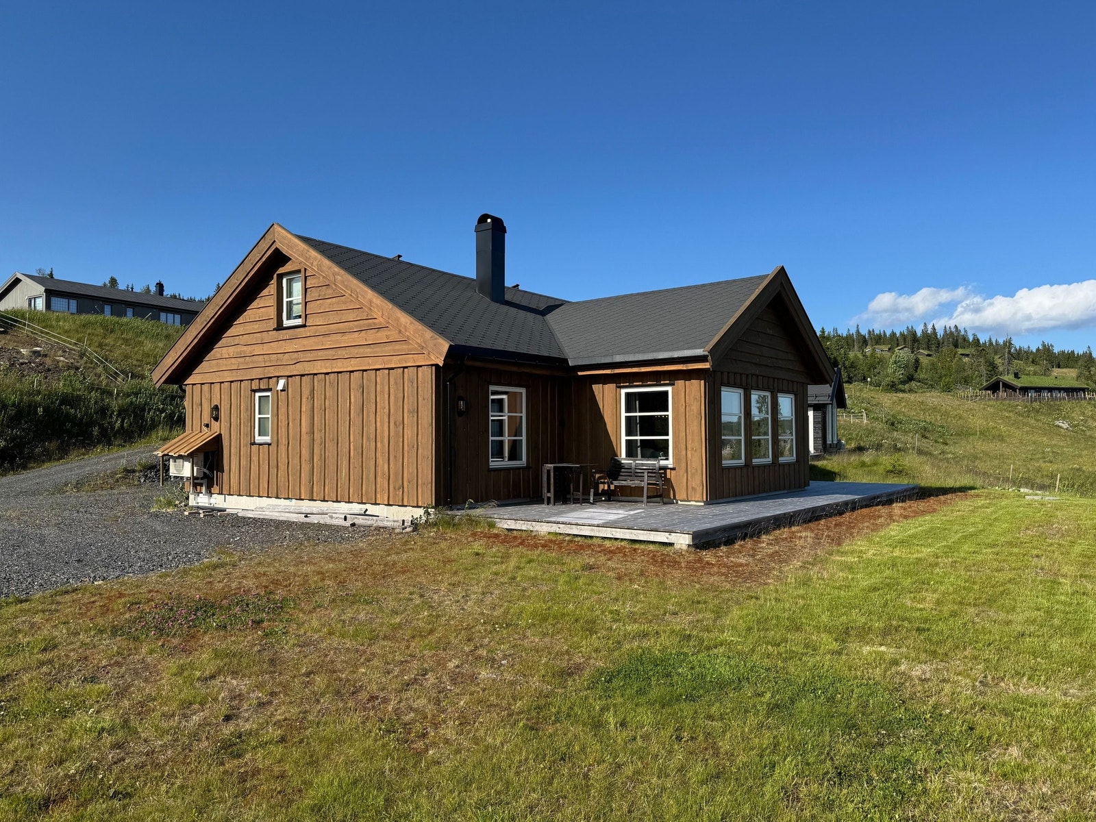 Hytten om sommeren. Det er sådd fjellgress i stedlig jord, som gir et fint fjellpreg. Galleribilde