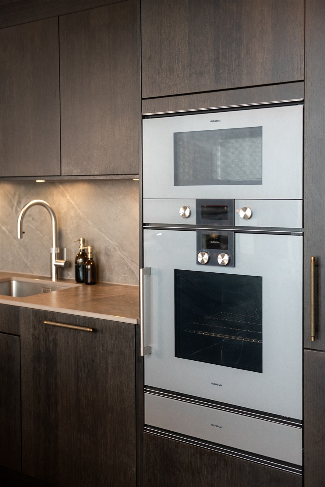 Hvitevarer fra kvalitetsleverandøren Gaggenau sikrer kvalitet i alle ledd - med ovn, mikrobølgeovn, varmeskuff, induksjonstopp, kjøleskap (Miele), Quooker og låsbart vinskap fra PeVino. Galleribilde