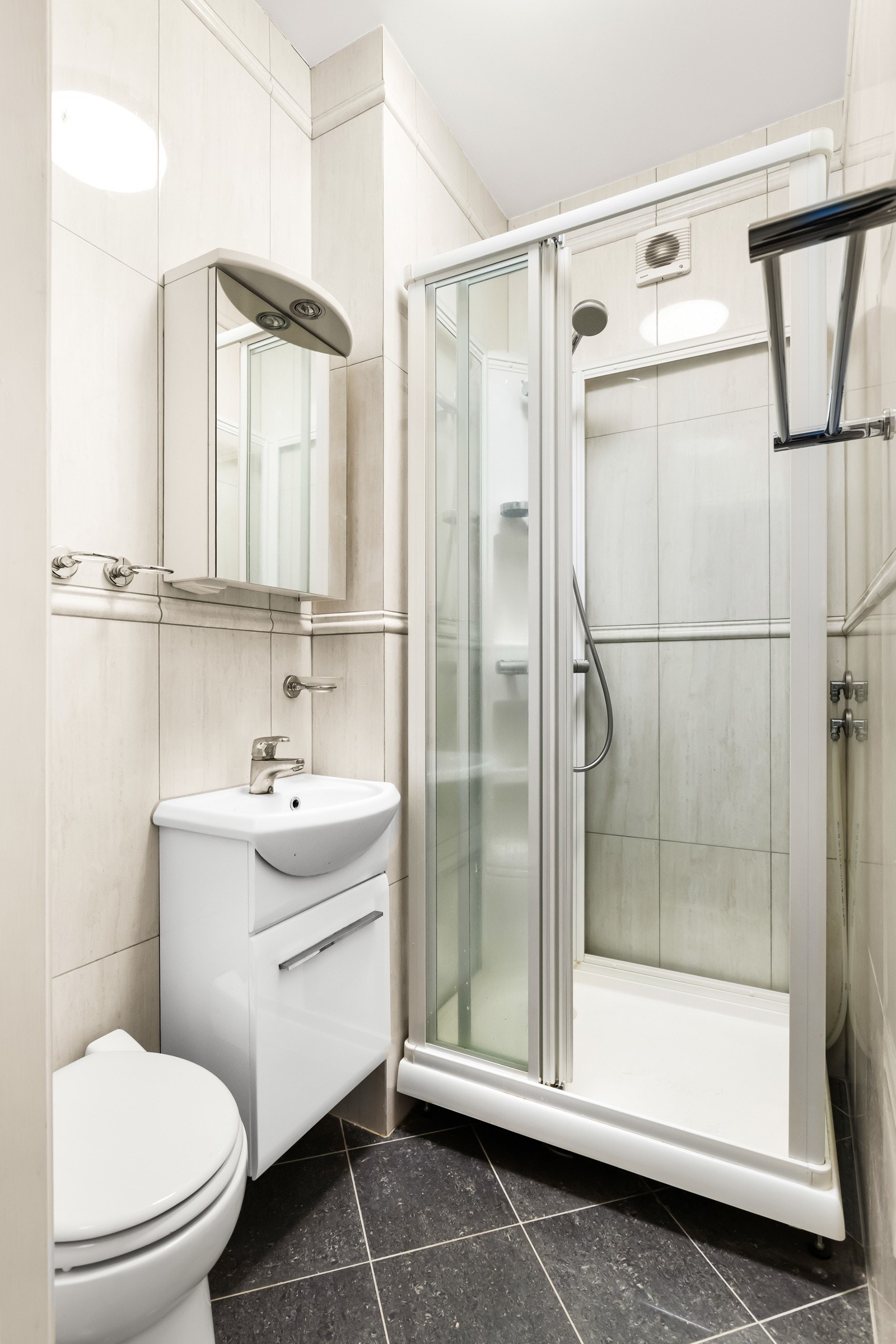 Bad 2. Flislagt bad med gulvvarme (disse er ikke funksjonstestet). Badet er innredet med baderomsmøbel med underskap og toppmontert servant. Over servanten er det montert et speilskap med integrert belysning. Badet har dusjkabinett samt et toalett. Galleribilde