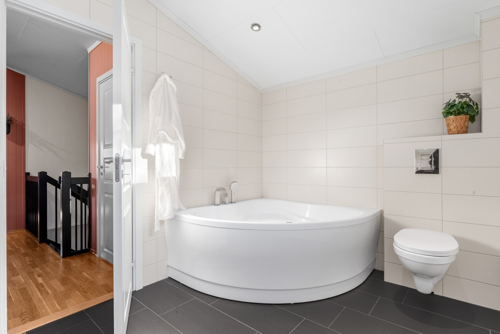 Badet på hele 8 m² byr på hjørnebadekar, vegghengt wc og en romslig innredning. Galleribilde