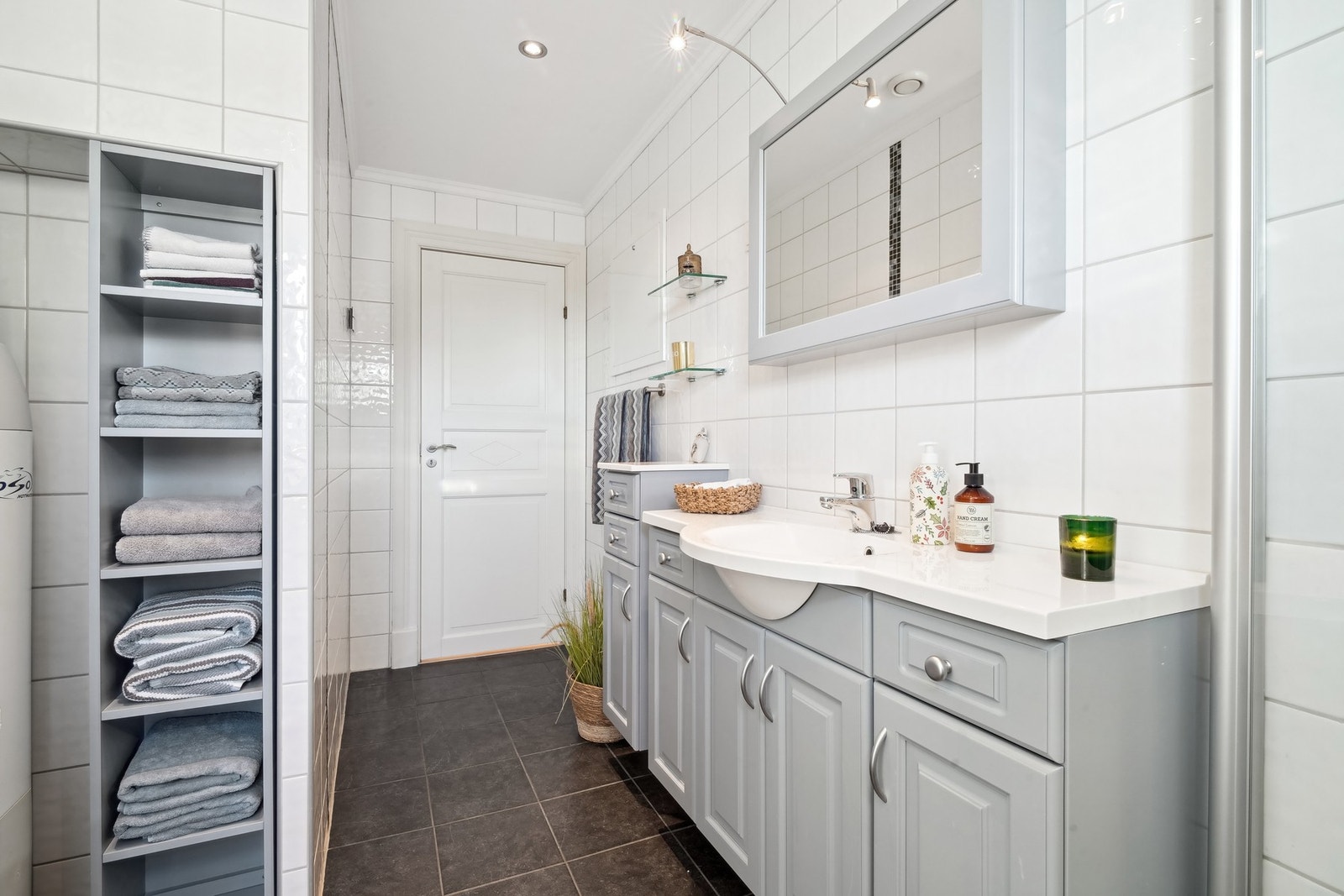 - baderomsinnredning med malte profilerte fronter, helstøpt porselensservant, speil og hylleinnredning. Galleribilde