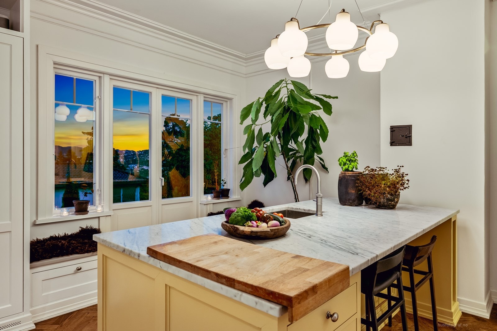 Det er utgang til steinbelagt uteplass og hagen fra kjøkkenet. Galleribilde