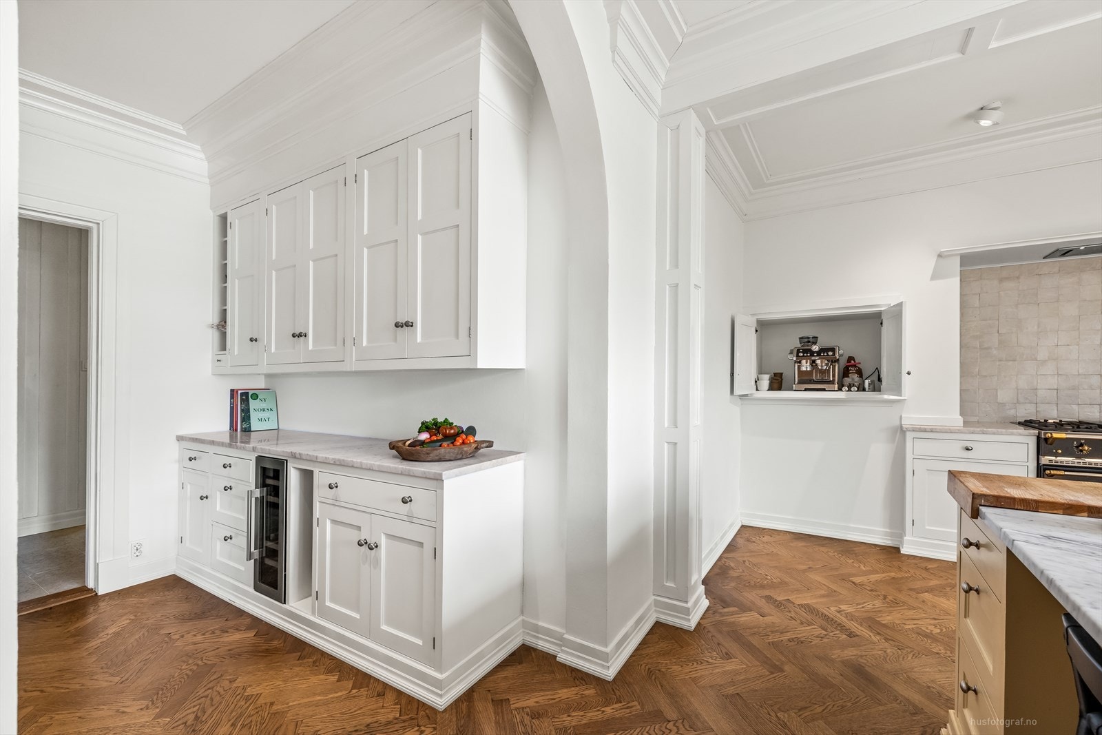 Gulvet er lagt med massiv eikeparkett i fiskebensmønster fra Hørning (2024), og det er vannbåren gulvvarme. Galleribilde