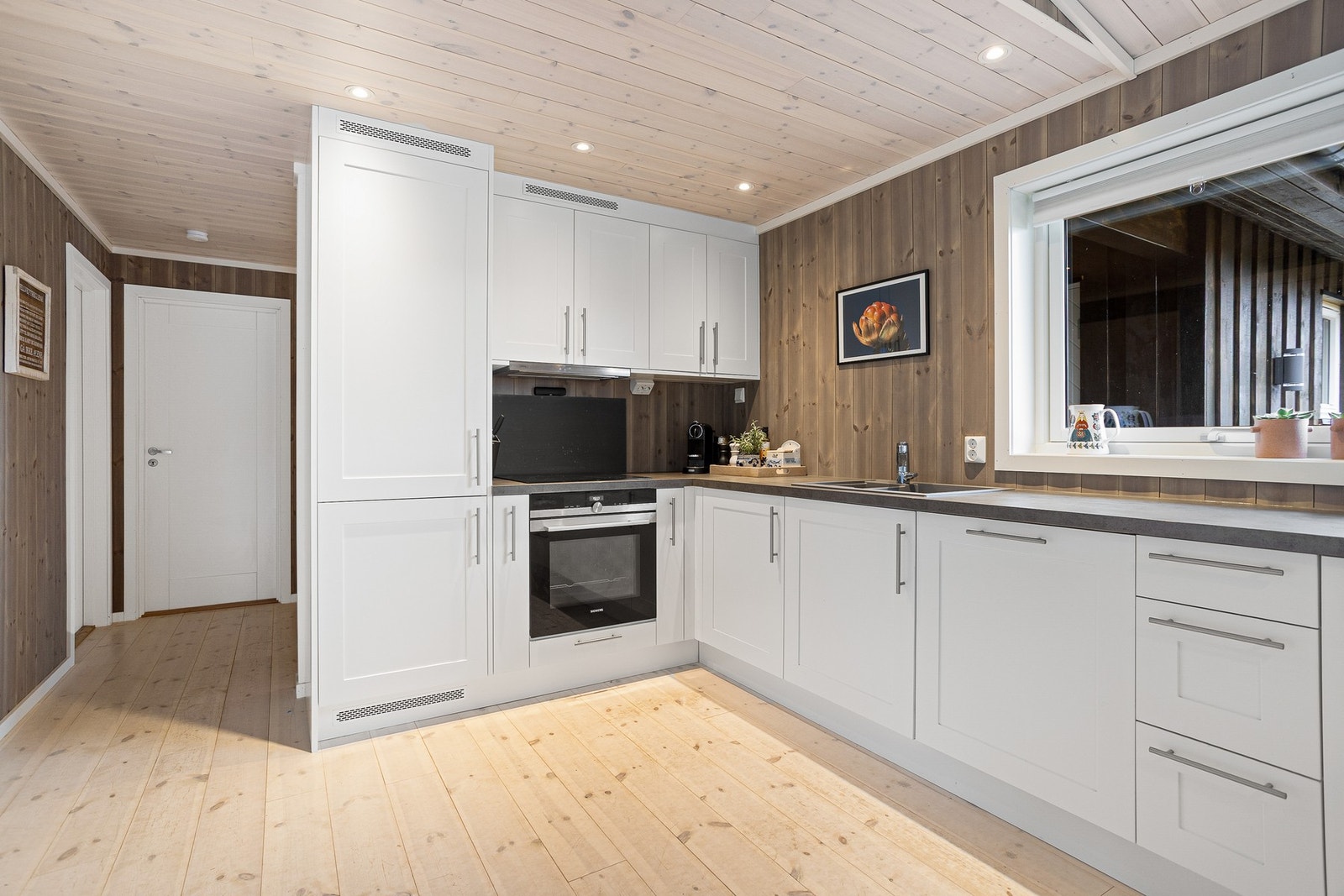 Kjøkkenet har integrerte hvitevarer. Downlights i himling gir godt med lys over kjøkkenbenken Galleribilde