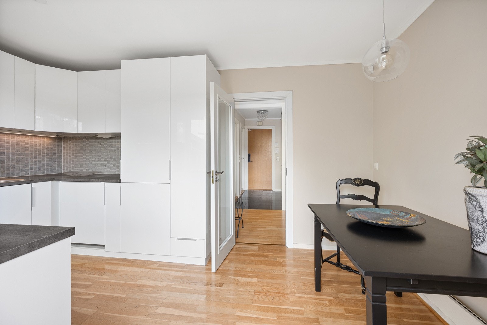 Innredningen har høyglansfronter, grå laminatbenkeplater og fliser på veggene. Galleribilde