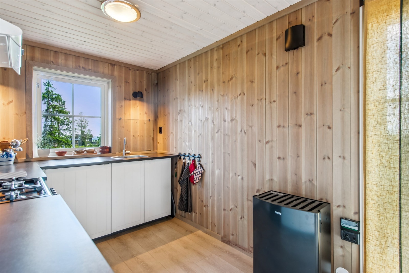Kjøkken med god benkeplass. Wallas parafin/dieselovn med utvendig tank (84l), med "Ring hytta varm"-funksjon er plassert i kjøkkensonen. Galleribilde