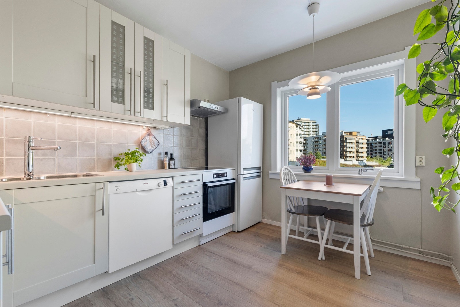 Lys og innbydende kjøkkeninnredning fra 2007 med rikelig skap- og benkeplass. Galleribilde