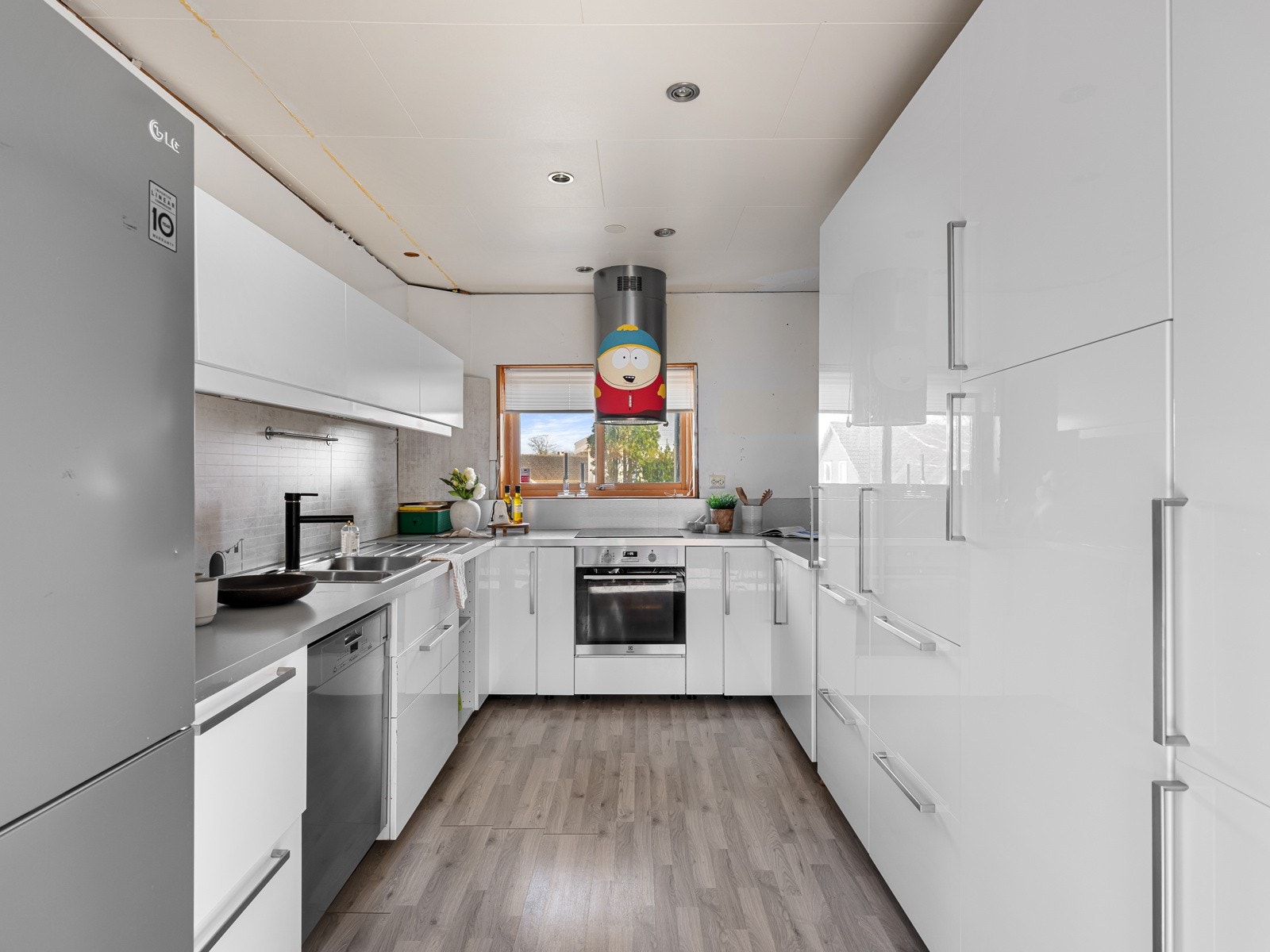 Hvit kjøkkeninnredning med god benke- og skapplass Galleribilde