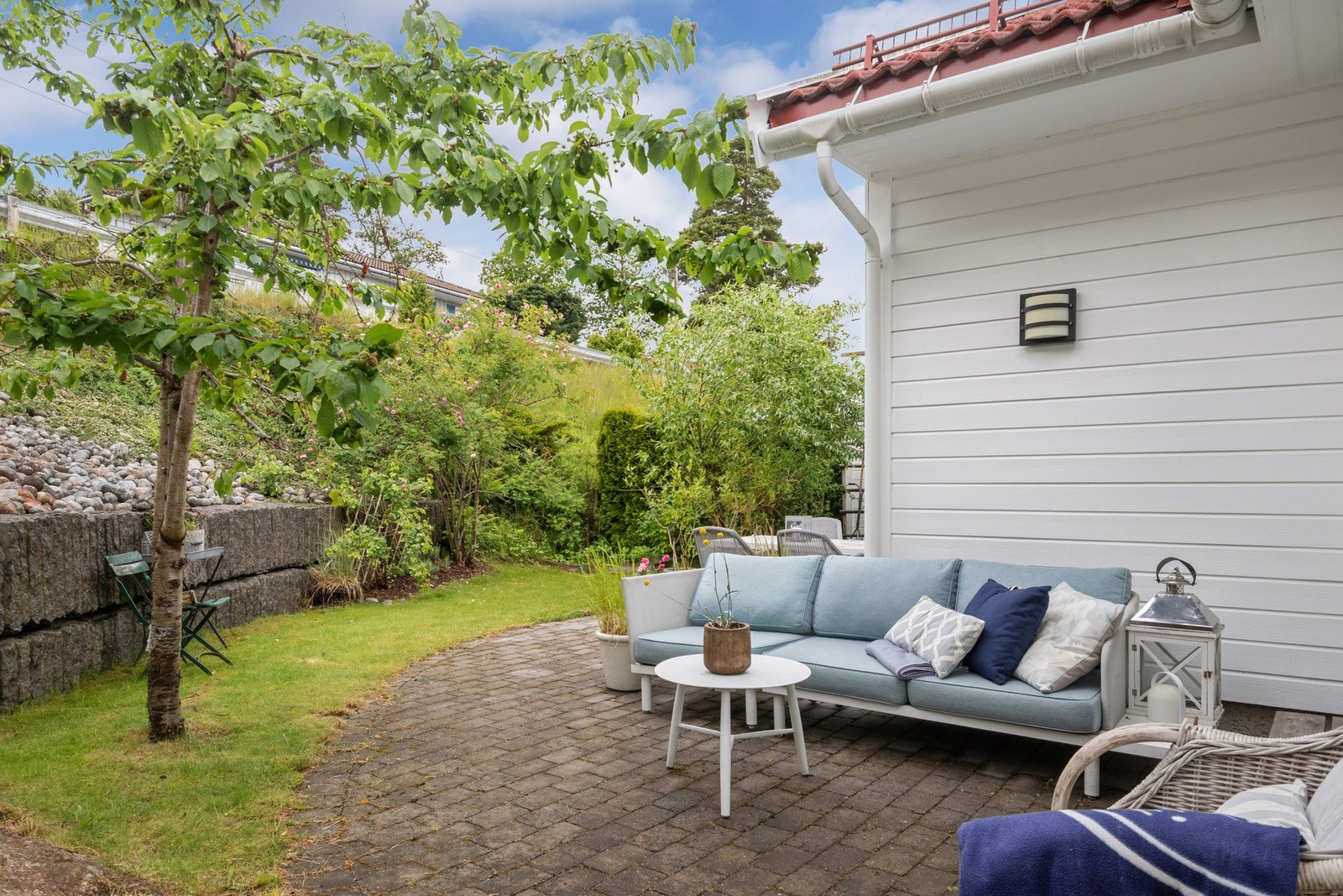 I hagen har boligen en usjenert uteplass med belegningsstein og adkomst fra stuen. Galleribilde