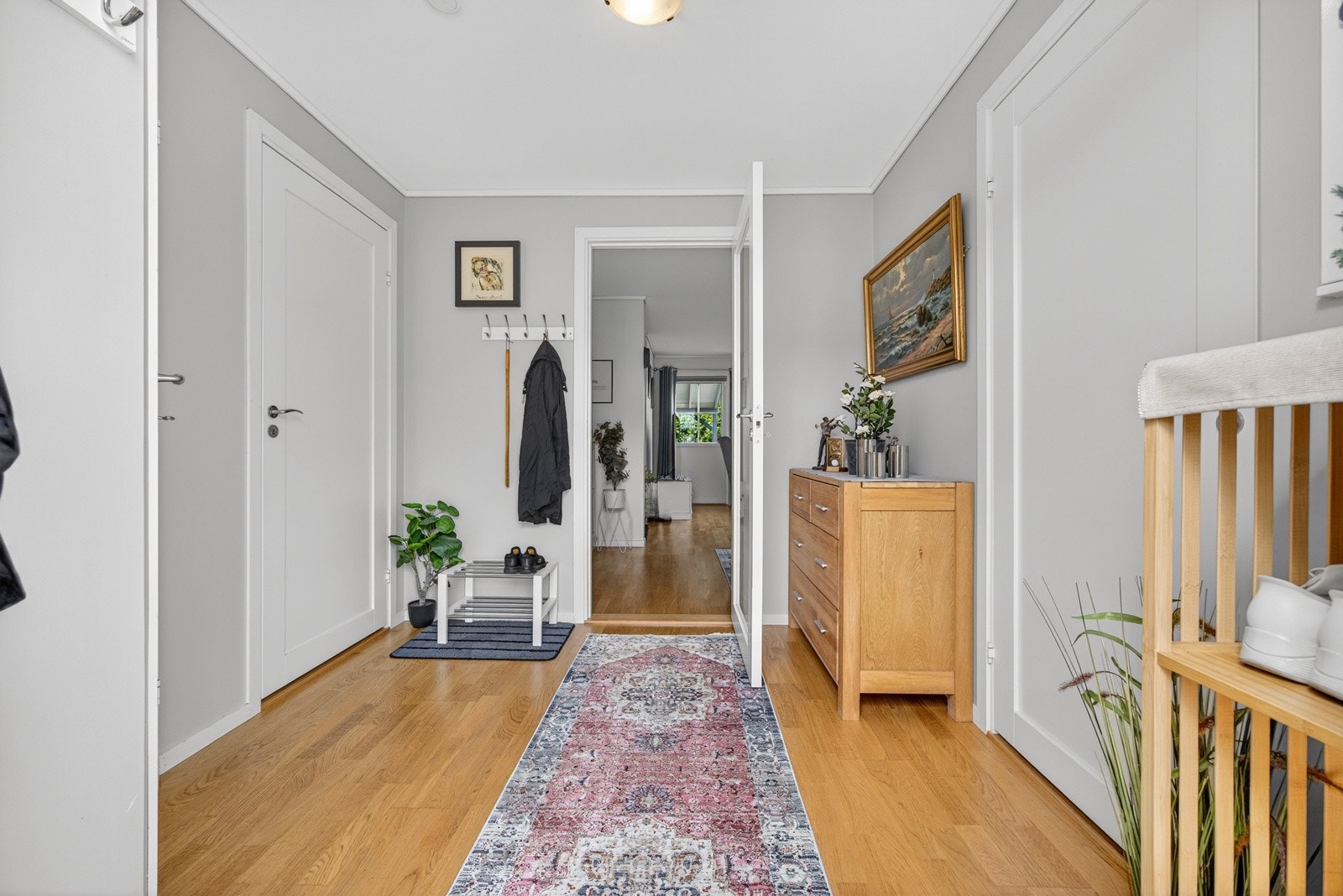 Lys og innbydende entrè med trestavs parkett på gulv med gulvvarme og malte veggflater som gir et godt førsteinntrykk av boligen. Fra entreèn er det inngang til soverom, vaskerom og WC. Galleribilde