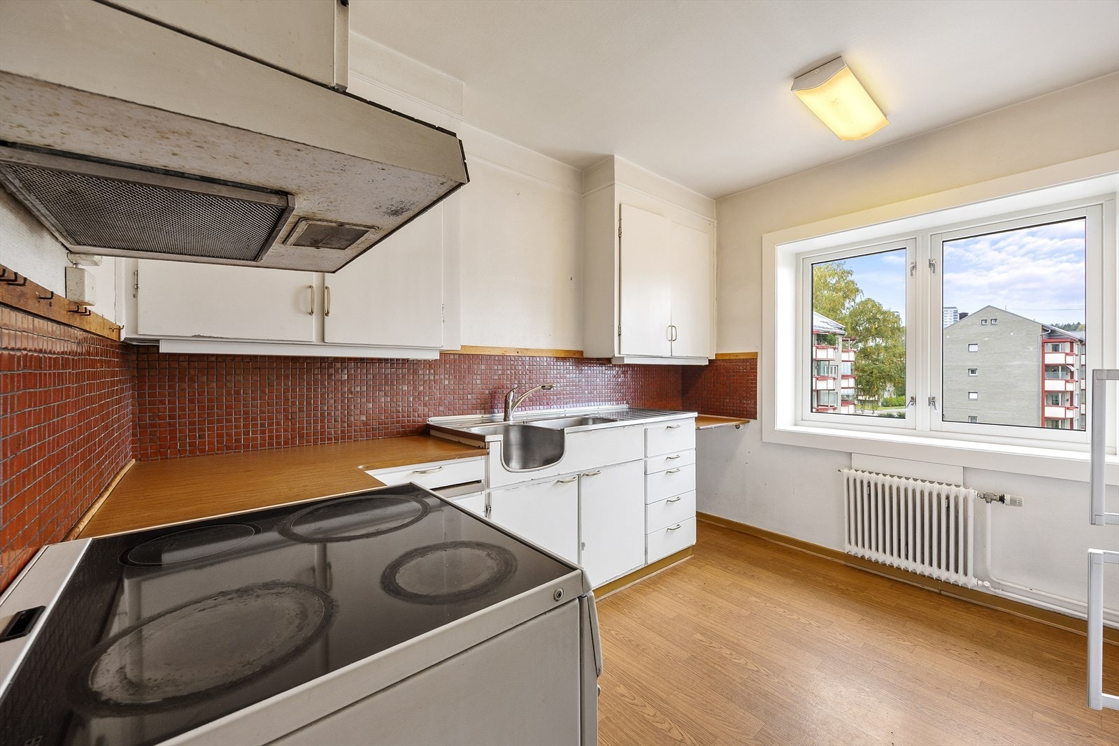 Kjøkkeninnredningen er av eldre stand, og har glatte skapfronter, laminat benkeplate, benkebeslag i rustfritt stål med utslagskum og kum. Det er avsatt nisje for å sette inn frittstående komfyr. Galleribilde