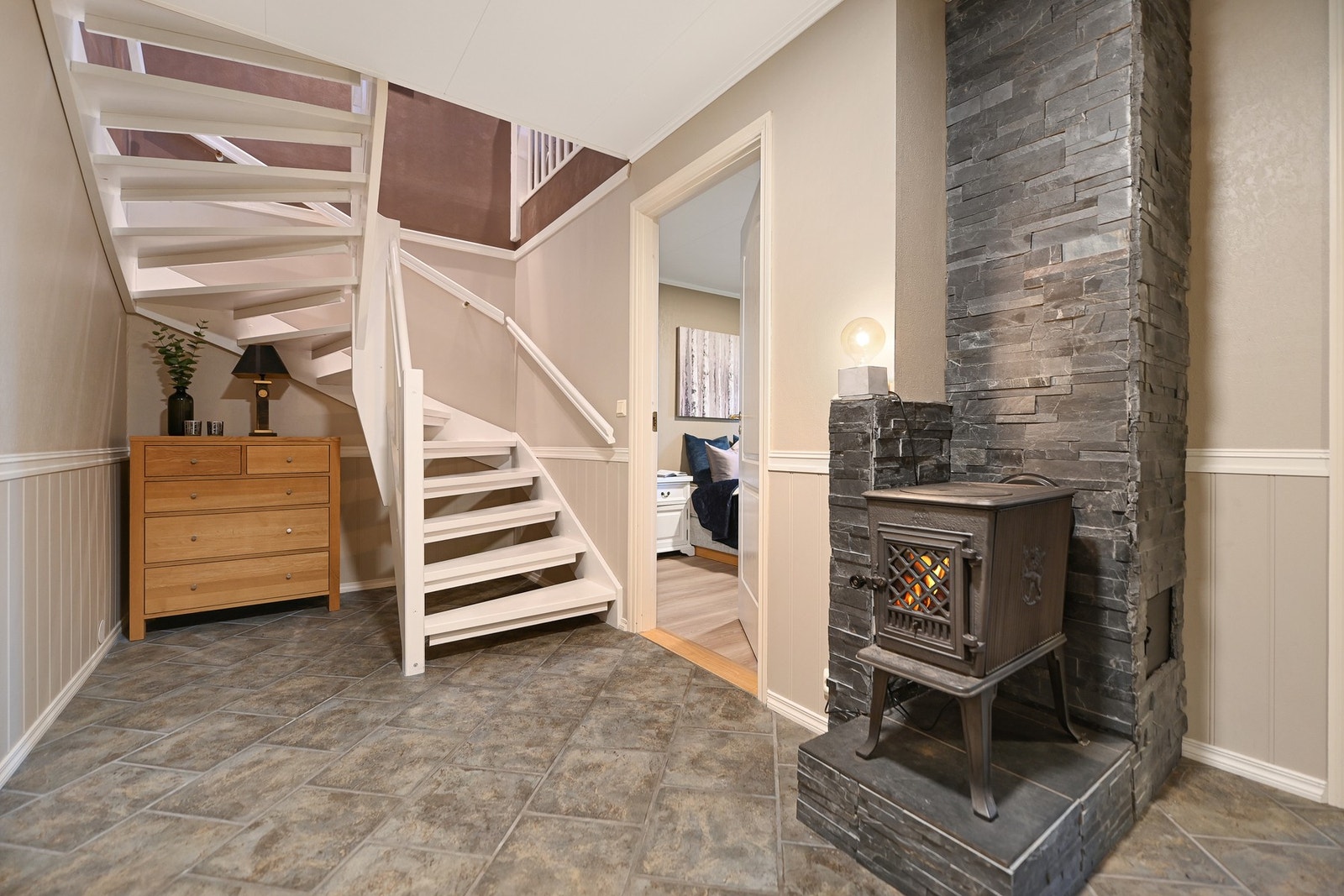 Romslig gang i u. etasje med lukket vedovn. Galleribilde