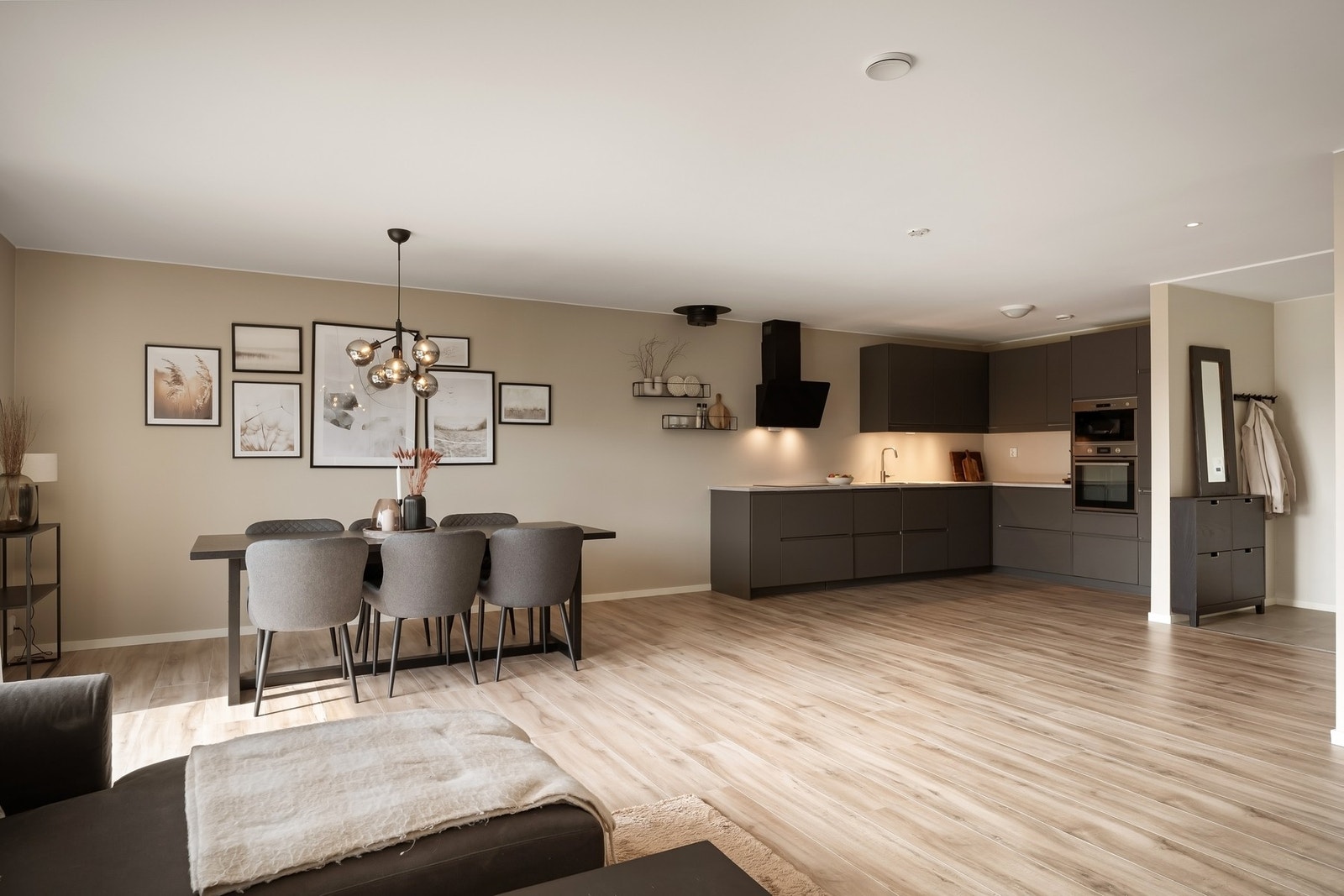 Åpen løsning mellom stue og kjøkken gir en behagelig romfølelse og naturlig flyt. Galleribilde