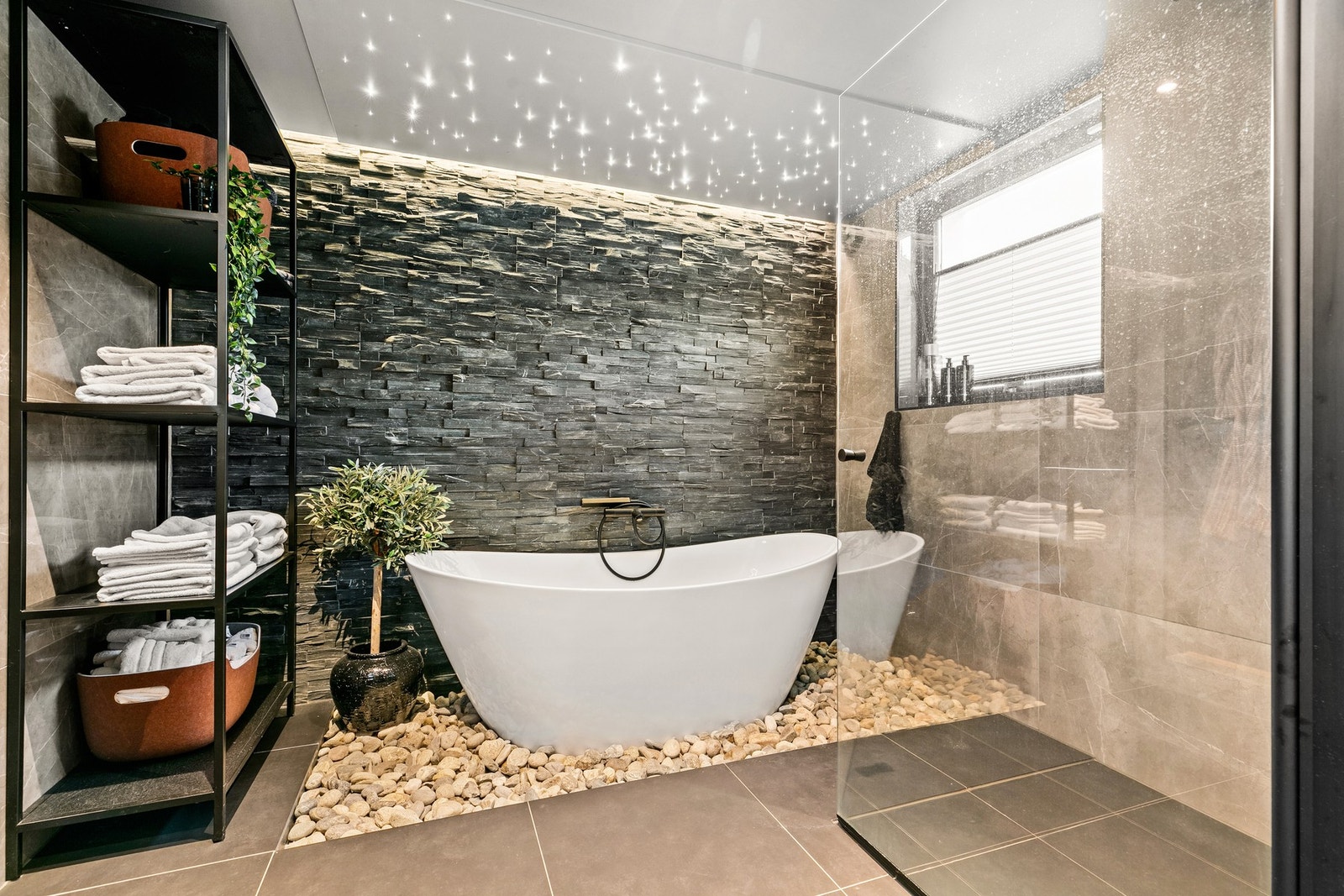 Det er avgrensning mot badekar og en separat dusjsone med skjermvegg i glass Galleribilde