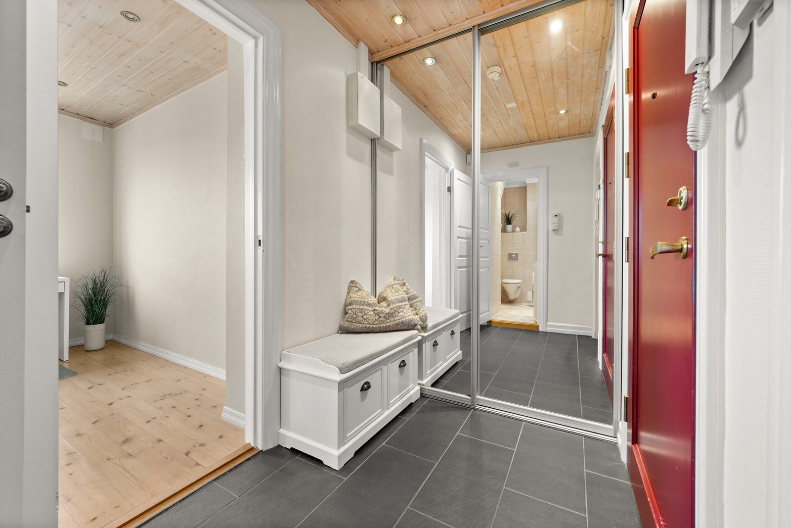 Velkommen inn! - Leiligheten har en romslig entre med flislagt gulv med gulvvarme og gode oppbevaringsløsninger for sko og yttertøy Galleribilde