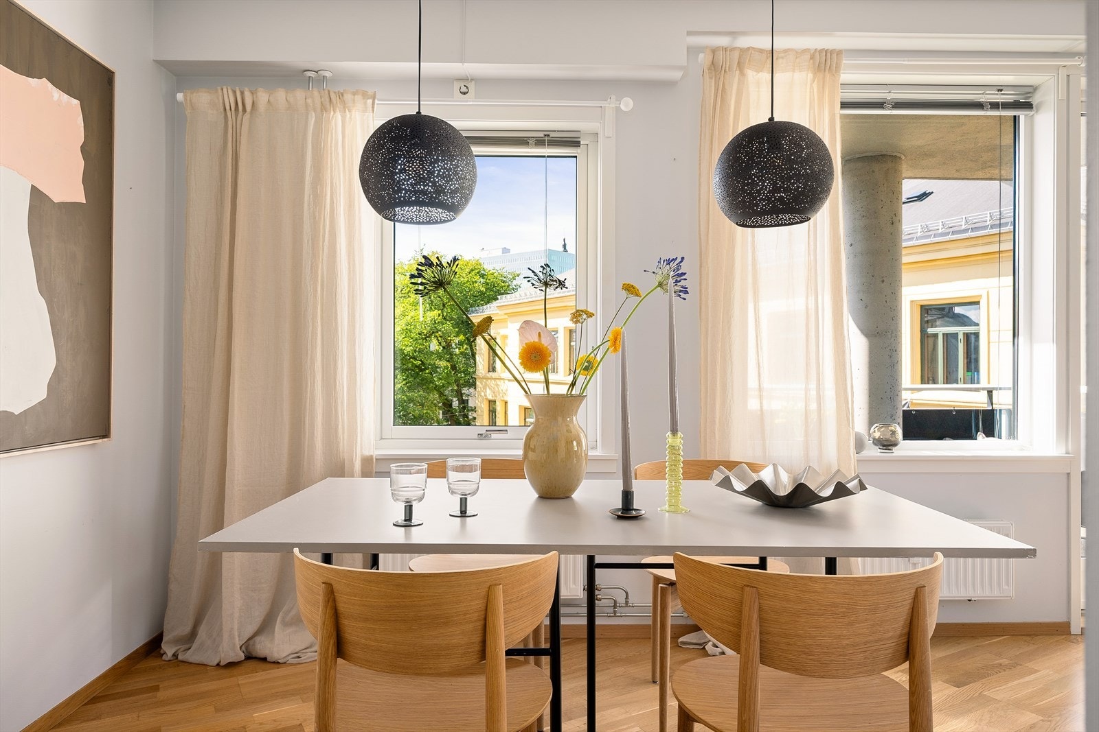 Fra spiseplassen har du utsikt til både grønne trær og byens sjarmerende bygg. Et lyst og luftig rom med klassiske kvaliteter. Galleribilde