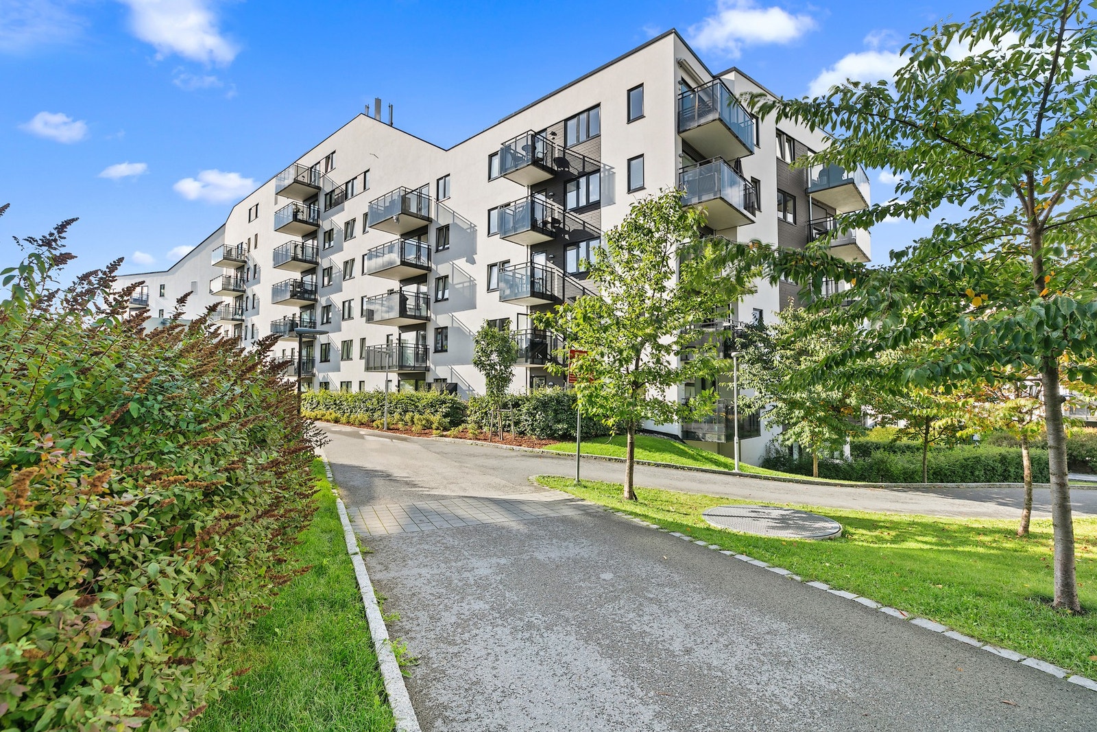 Fellesområdene har asfalterte gangstier og et frodig hageareal med pergola. Galleribilde