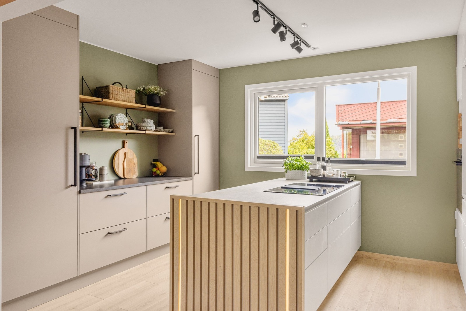 Kjøkkenet har en praktisk innredning med en sosial kjøkkenøy for godt med arbeidsplass, samt godt med oppbevaringsplass i skuffer og skap. Galleribilde