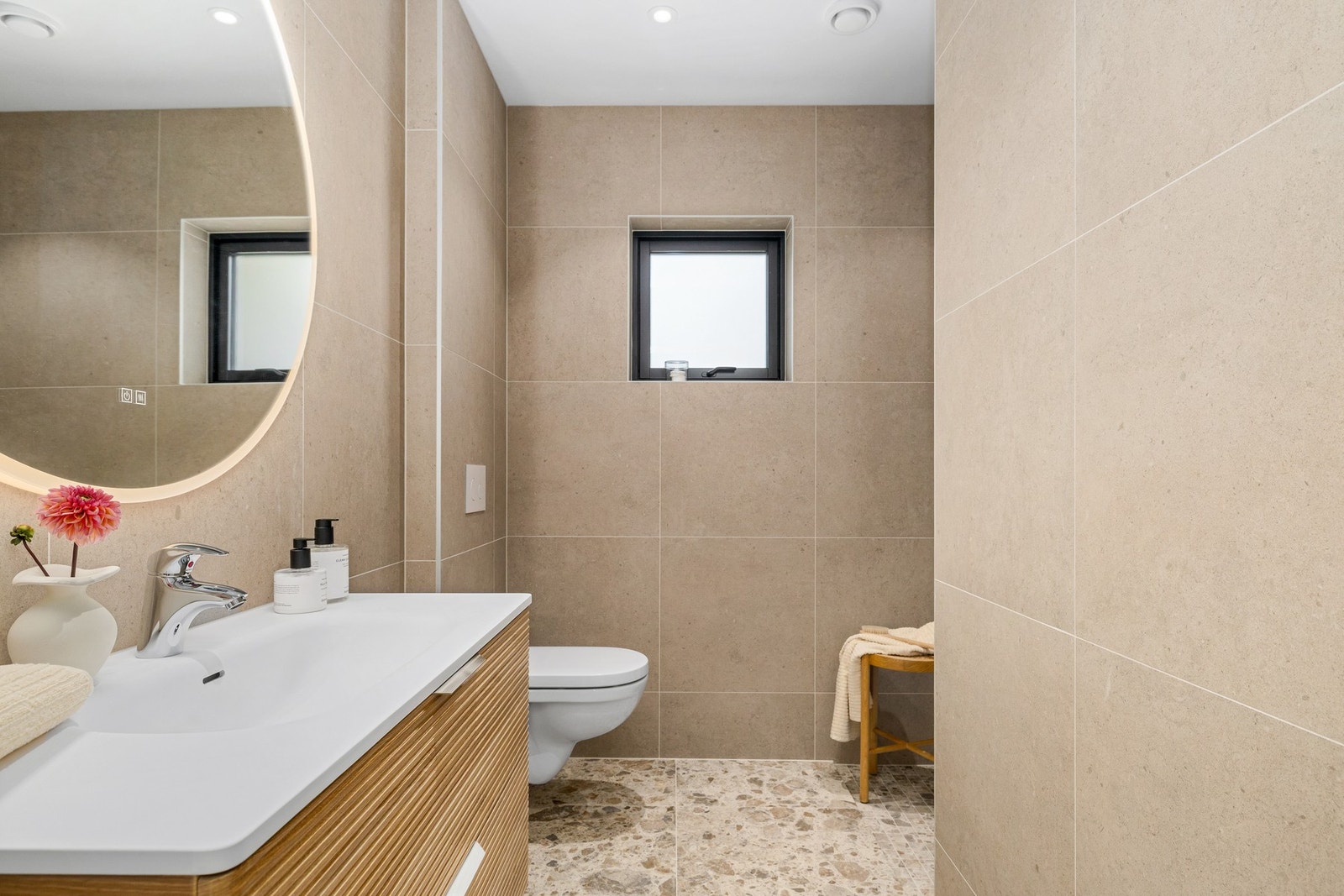 Fra stue/kjøkken og soverom har du et pent og smakfullt flislagt bad Galleribilde