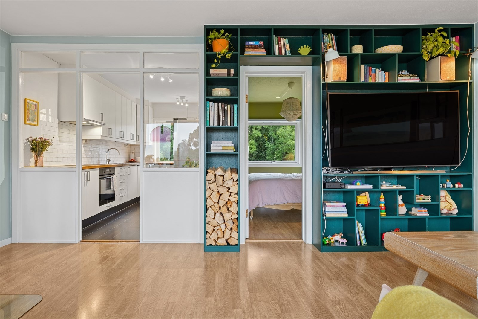 Stuen fungerer som en naturlig rominndeler og binder sammen kjøkken, gang og balkong på en praktisk og harmonisk måte. Galleribilde