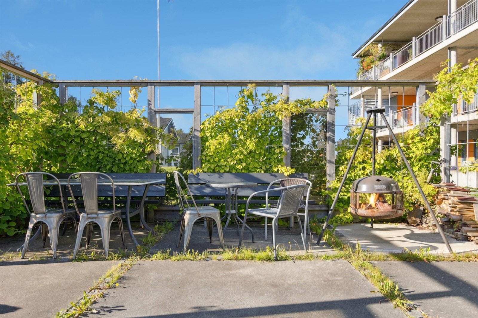 Utenfor boligen finner du et trivelig felles uteområde med benker, solplasser og en bålpanne, perfekt for hyggelige stunder utendørs. Galleribilde