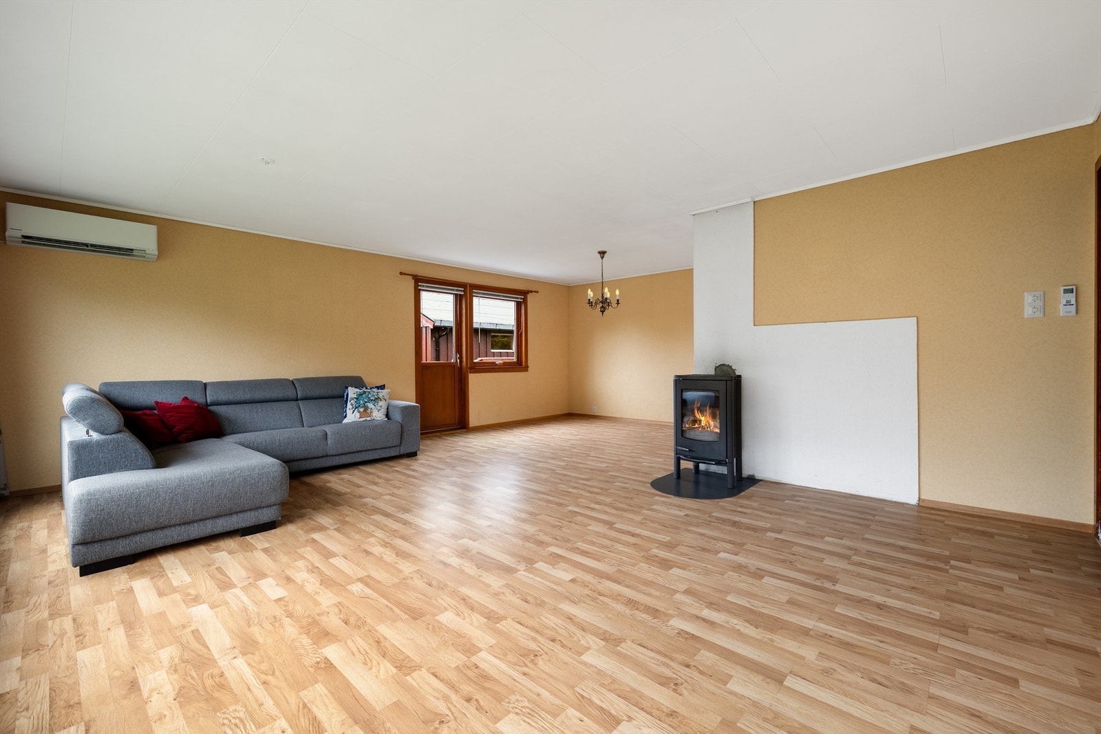 Stuen har lun vedovn, varmepumpe og utgang til veranda. Galleribilde