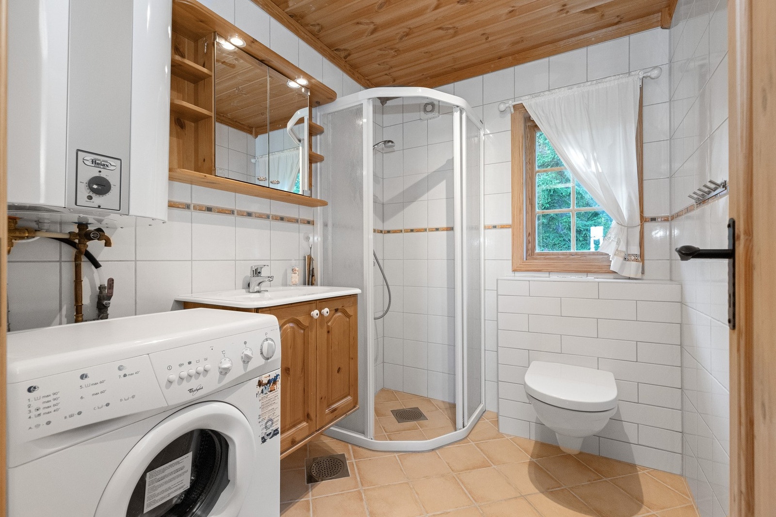 Badet har flislagte overflater på vegger og gulv Galleribilde