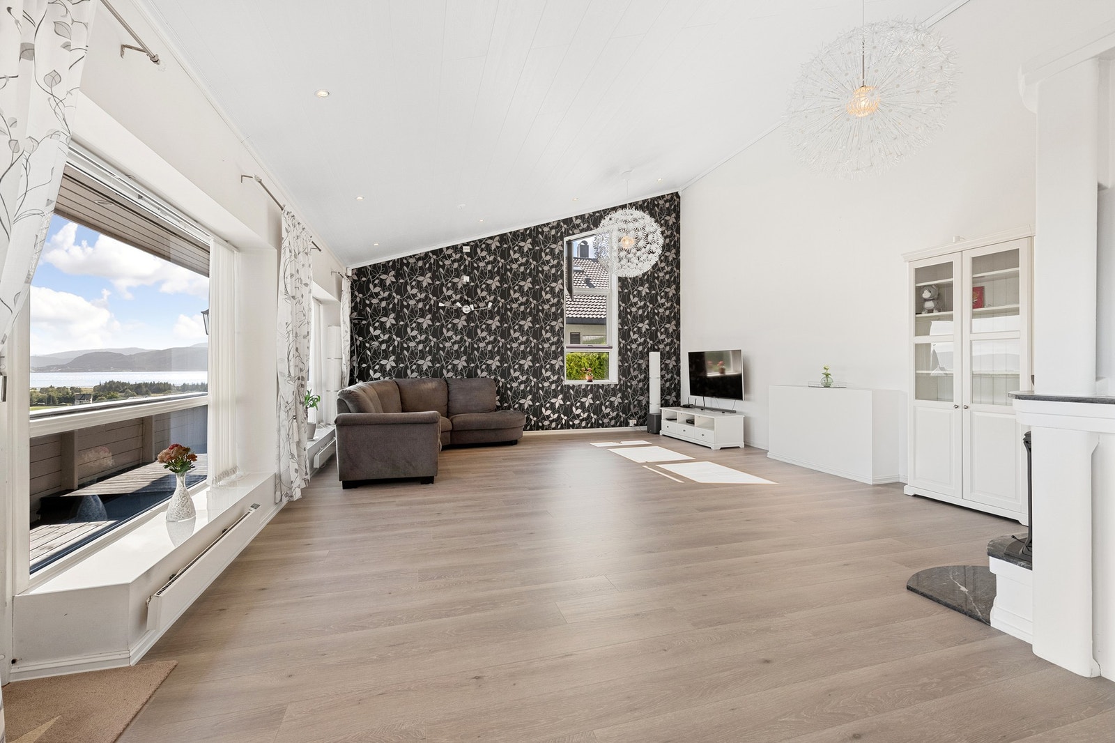 Romslig stue med store vinduer og mye naturlig lys. Galleribilde