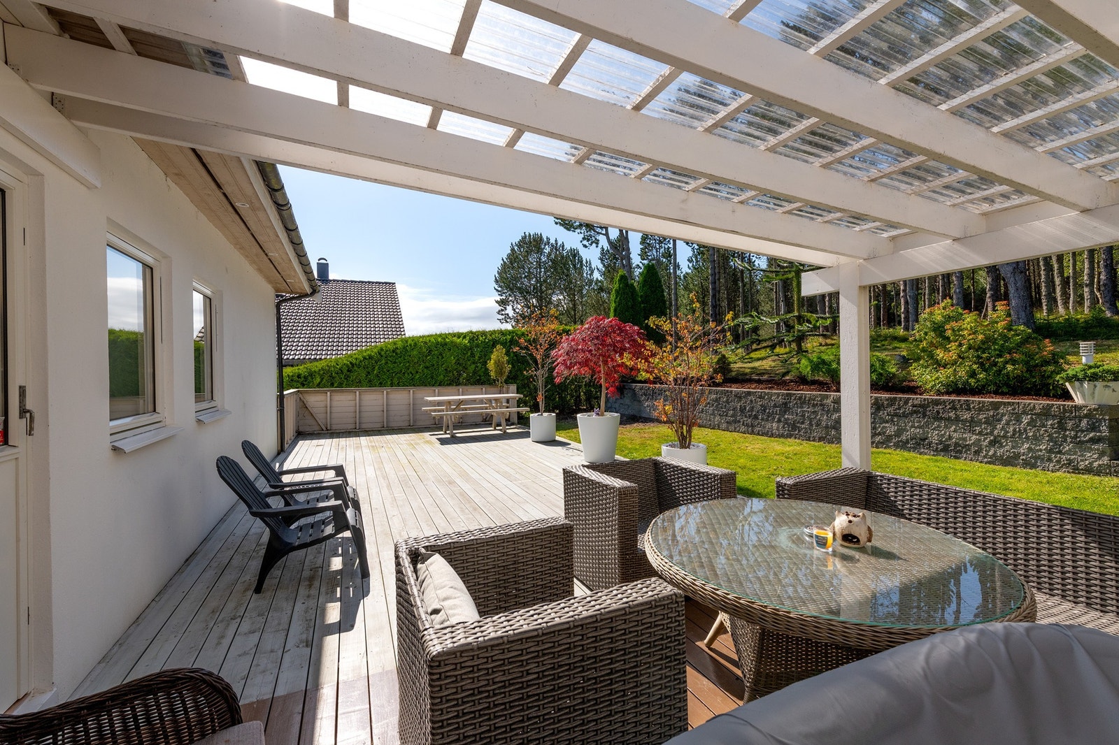 Koselig uteplass med tak og hagemøbler - fint område for avslapping og måltider ute. Galleribilde