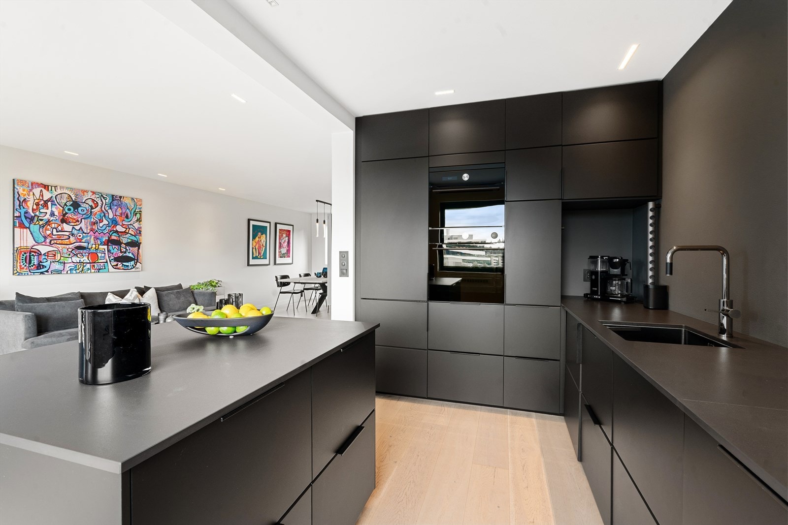 Kjøkkenet har et tidsriktig uttrykk med masse lagringsplass og godt med benkeplass for matlaging. Galleribilde