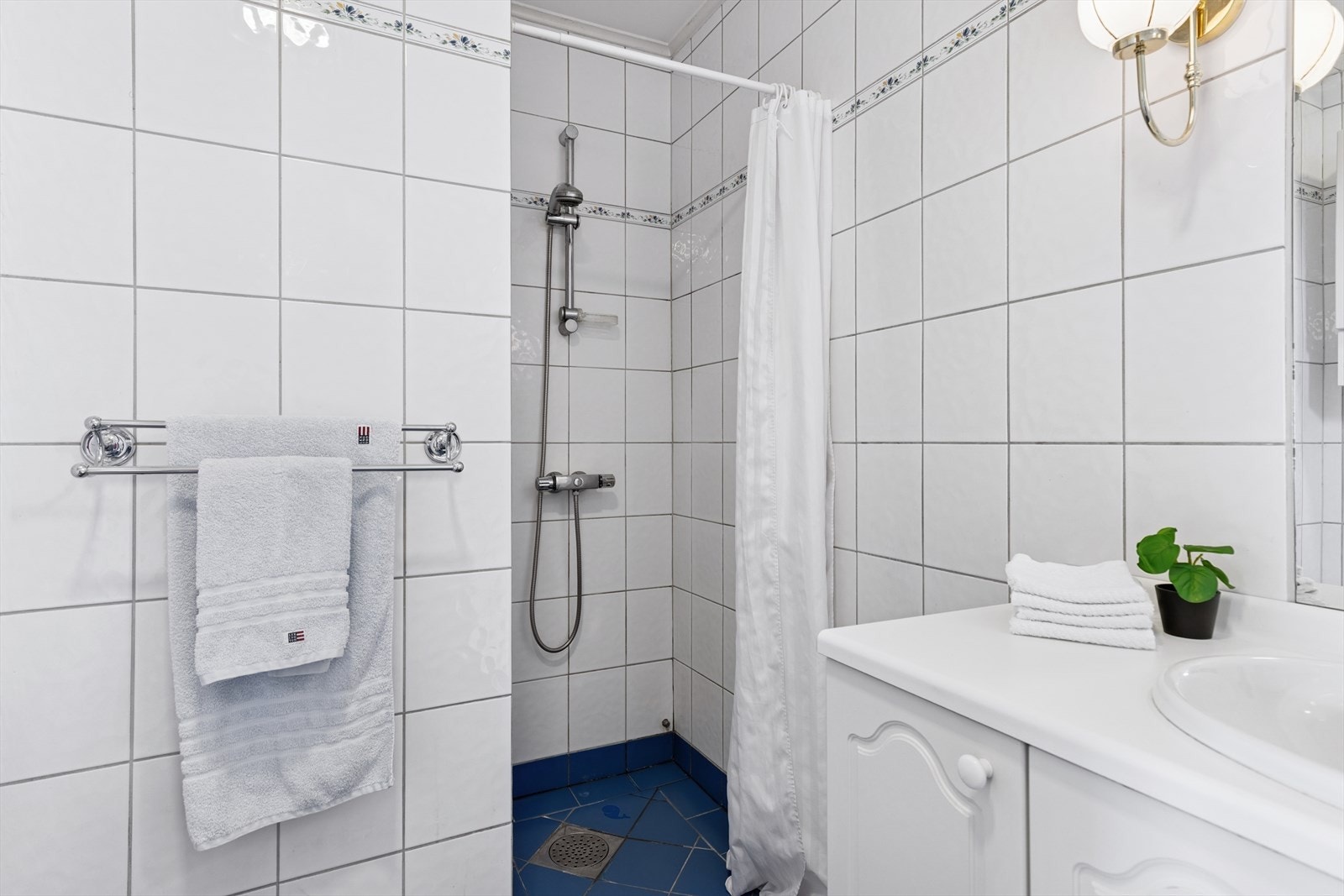 Dette badet er utstyrt med badekar, dusjnisje og servant med skapinnredning Galleribilde