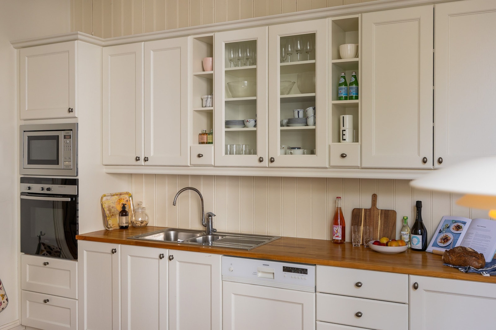 Kjøkkenet er utstyrt med integrerte hvitevarer, inkludert stekeovn, oppvaskmaskin, mikrobølgeovn og induksjonstopp. Galleribilde