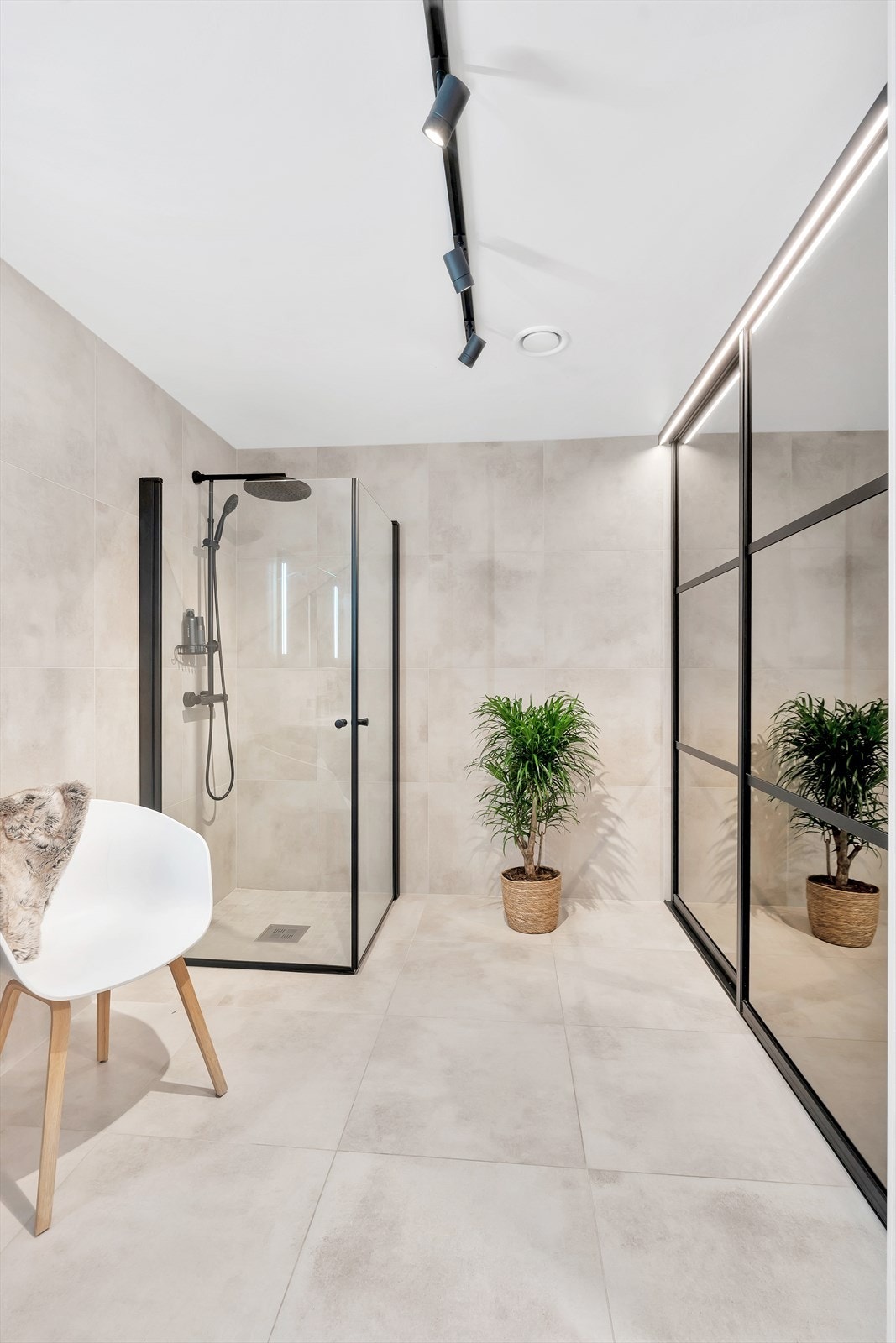 Badet er romslig, og innredet med skyvedørsgarderobe som blant annet skjuler vaskemaskin/tørketrommel og annen oppbevaring. Galleribilde