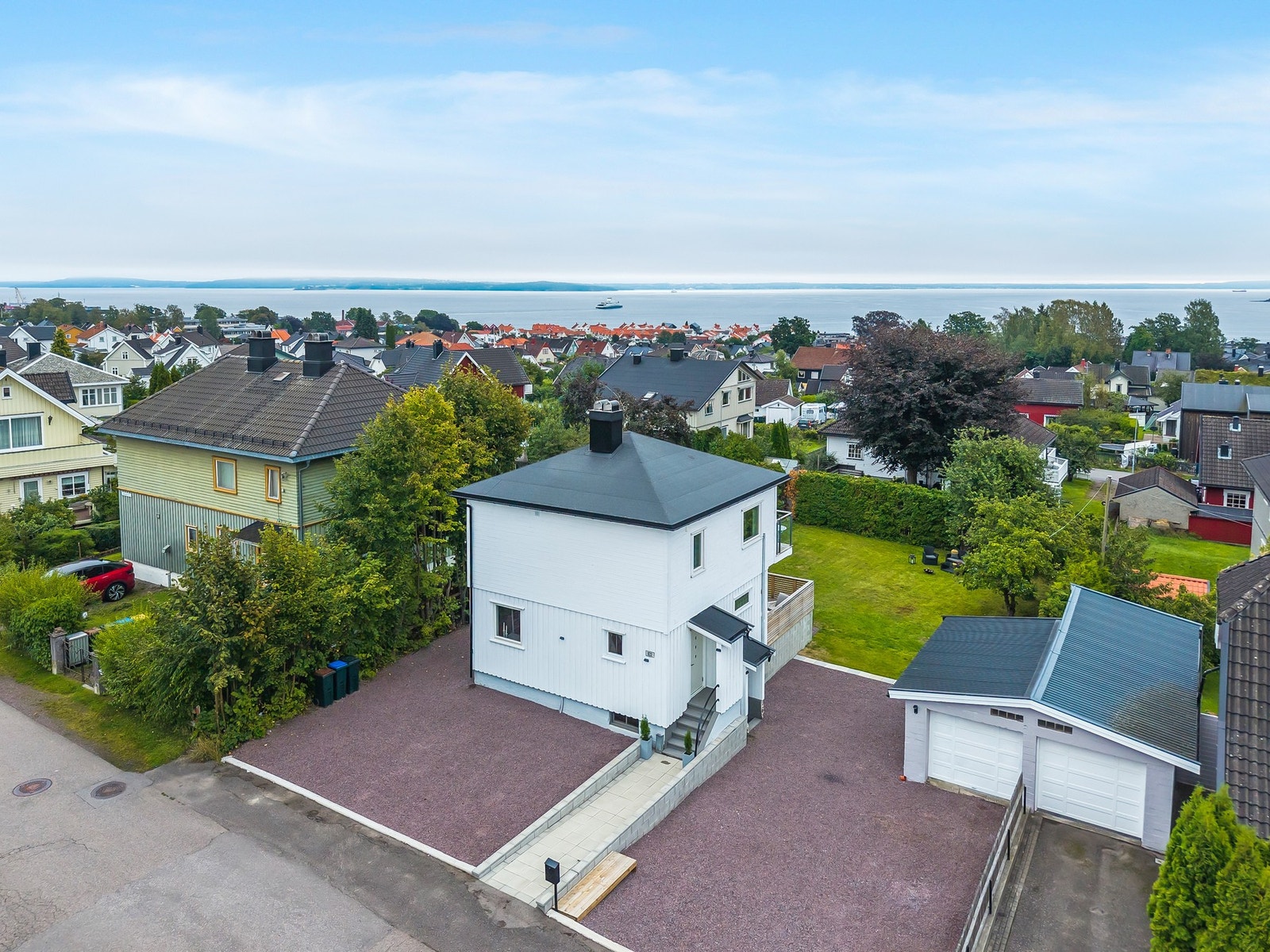 Attraktiv beliggenhet på populære Tveiten - med kort vei til sentrum og glimt av sjøen. Det er satt opp gjerde langs veien etter at bildet er tatt. Galleribilde