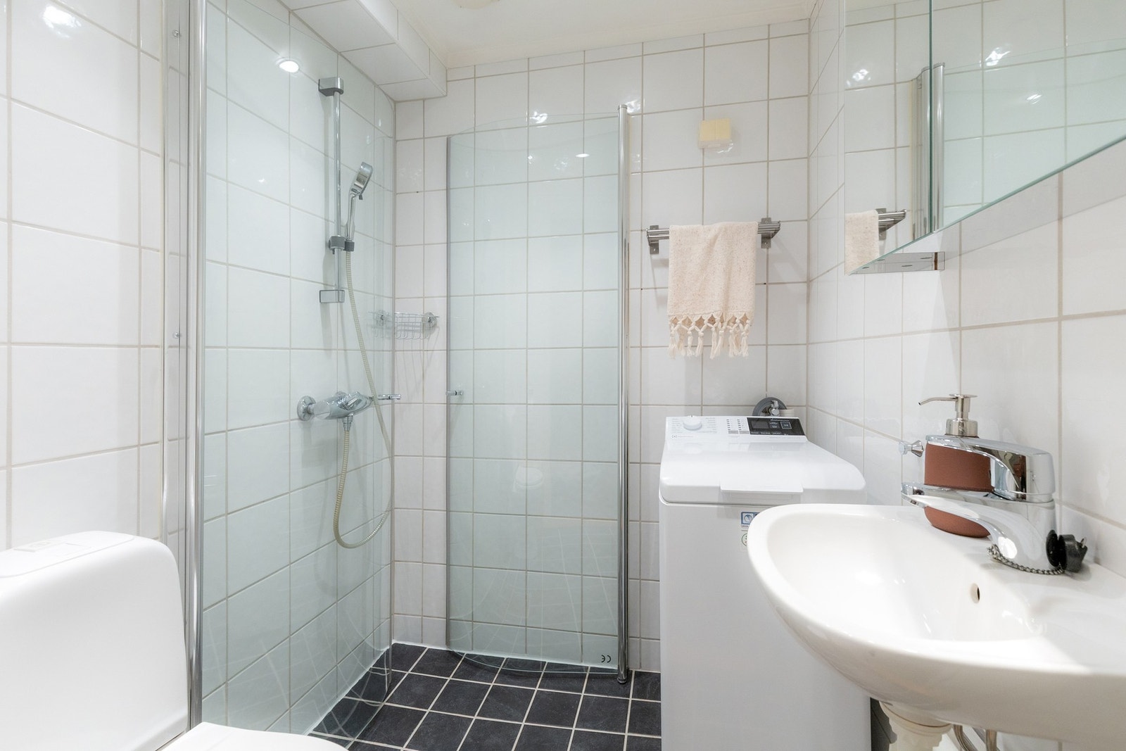 Pent flislagt bad med gulvvarme og malt himling med downlights. Galleribilde