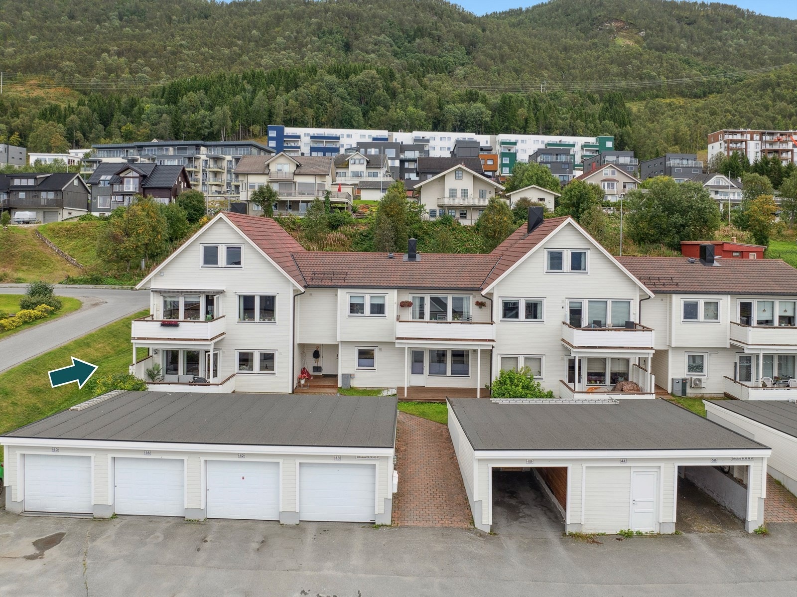 Leiligheten befinner seg på enden mot nord i u.etg. Overbygget felles inngangsparti. Parkering i garasje i rekke Galleribilde