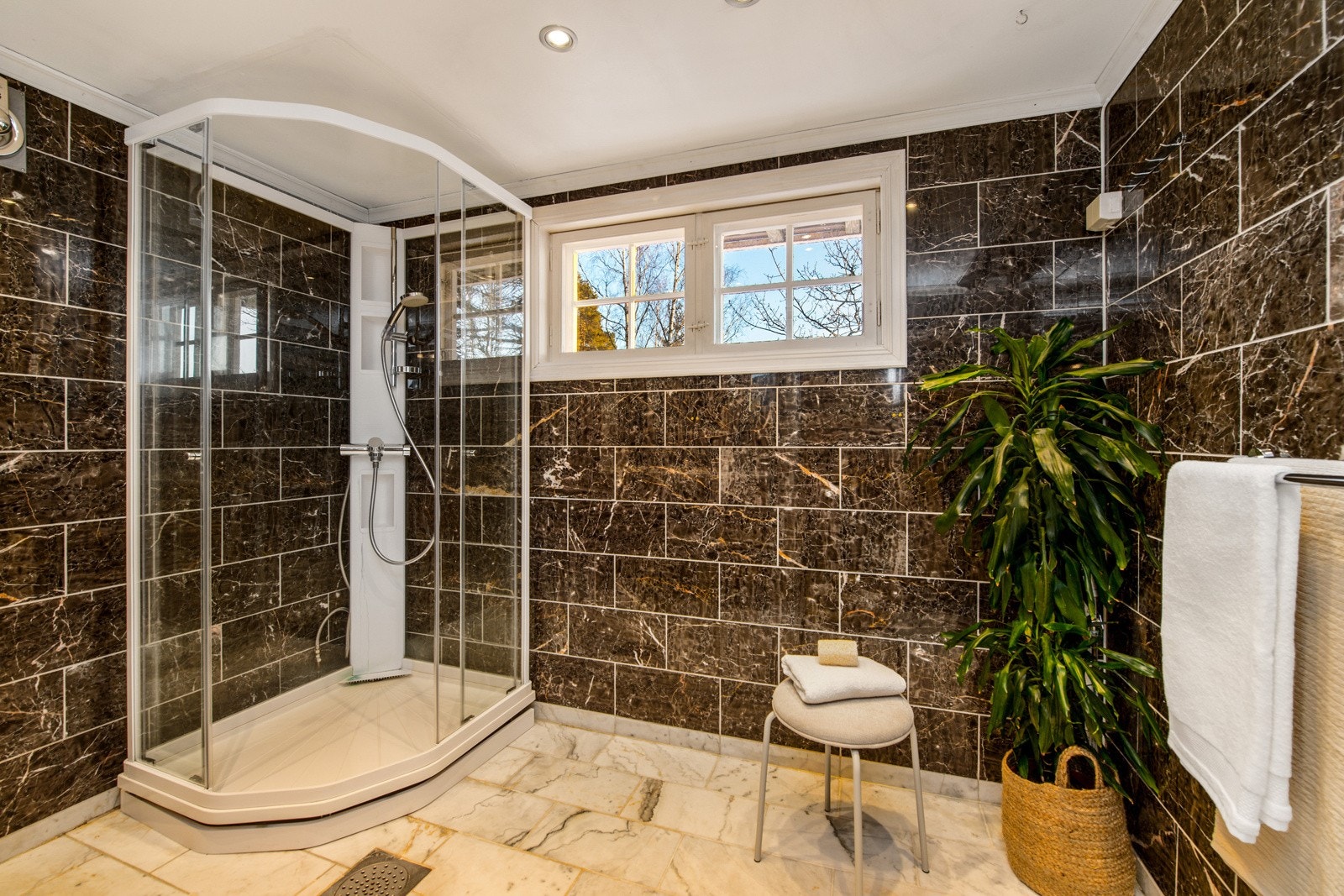 Badet nede er fra 2005, innredet med vegg- og gulvfliser i marmormønster. Galleribilde