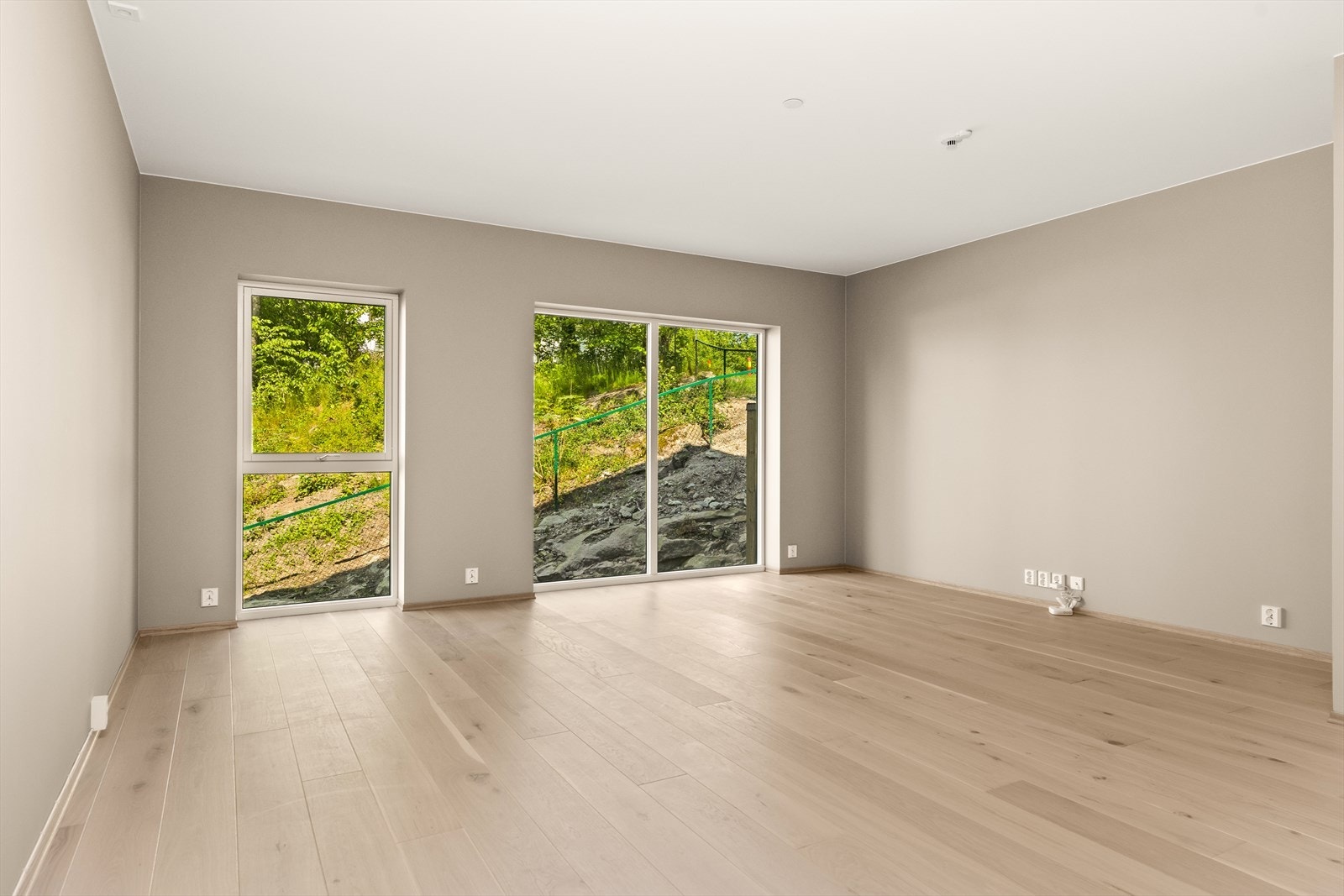 Her er det romslig stue med store vinduer Galleribilde