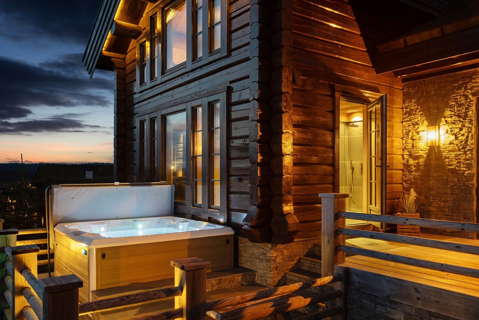 Støpt terrasse med jacuzzi på 13 kvm, belagt med skiferflis og med rekkverk i rundstokk. Galleribilde