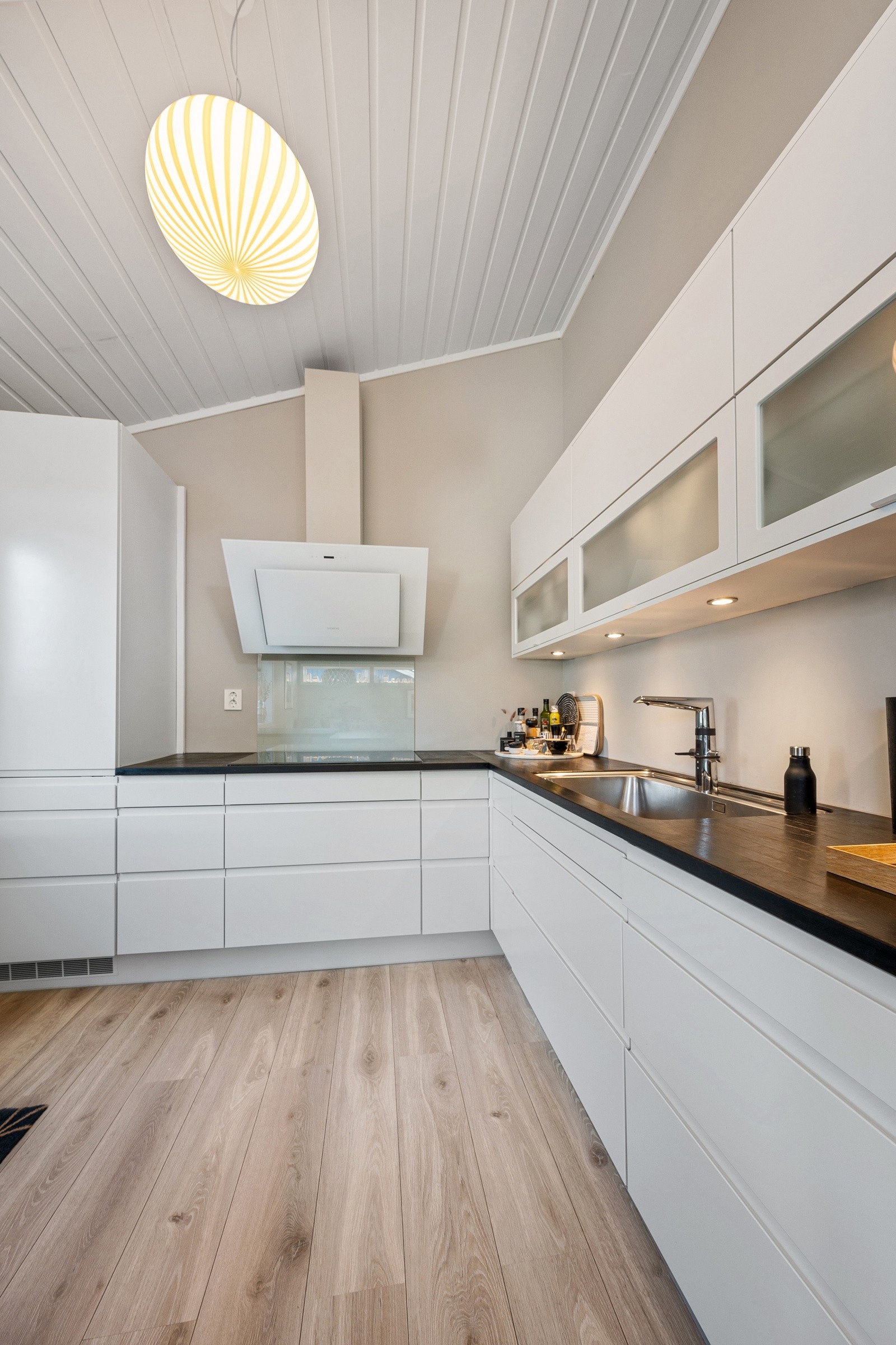 Lyst og moderne kjøkken med innredning fra HTH og benkeplate i heltre eik.