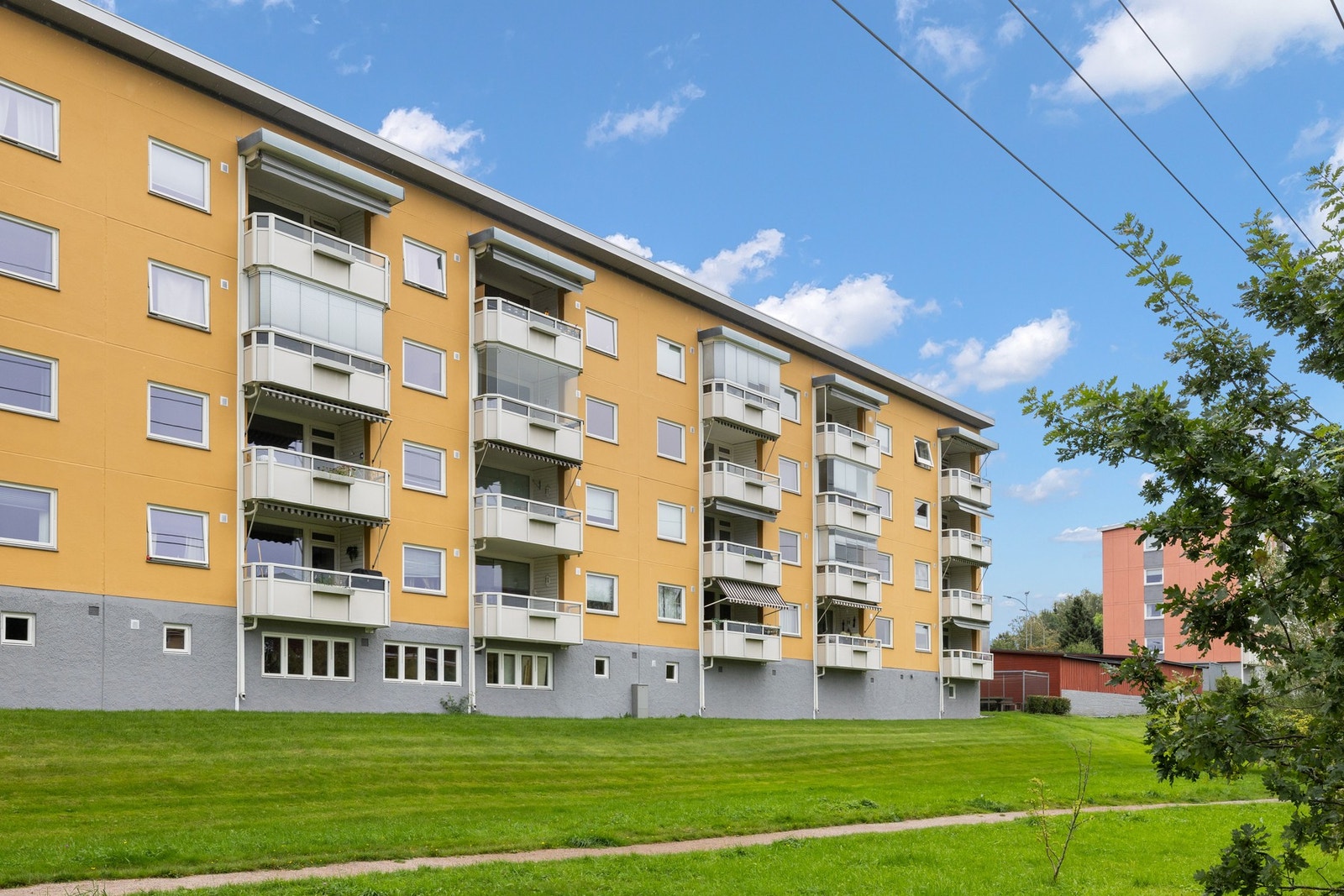 Fellestomten består av opparbeidede fellesarealer med gressplener, variert vegetasjon, bord, benker og lekeplasser samt asfalterte gang- og stikkveier. Galleribilde