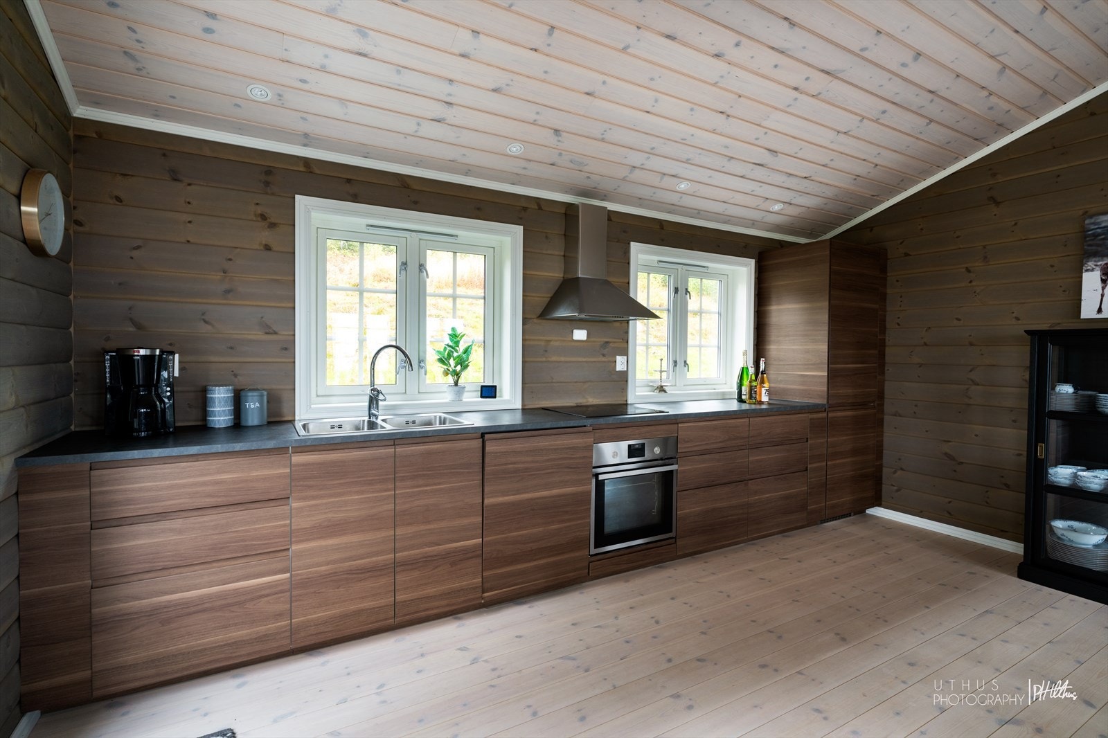 Åpen kjøkkenløsning med glatte fronter og laminerte benkeplater, som gir et moderne og innbydende preg. Galleribilde